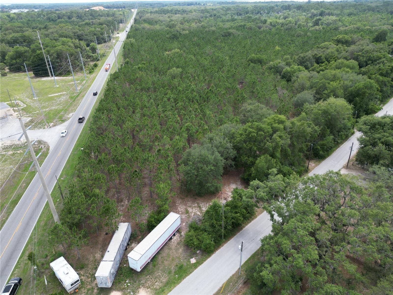 9300 E TREASURE ISLAND AVENUE, Leesburg, FL 34788 An aerial photo of the site from the northeastern corner, oriented southwest.