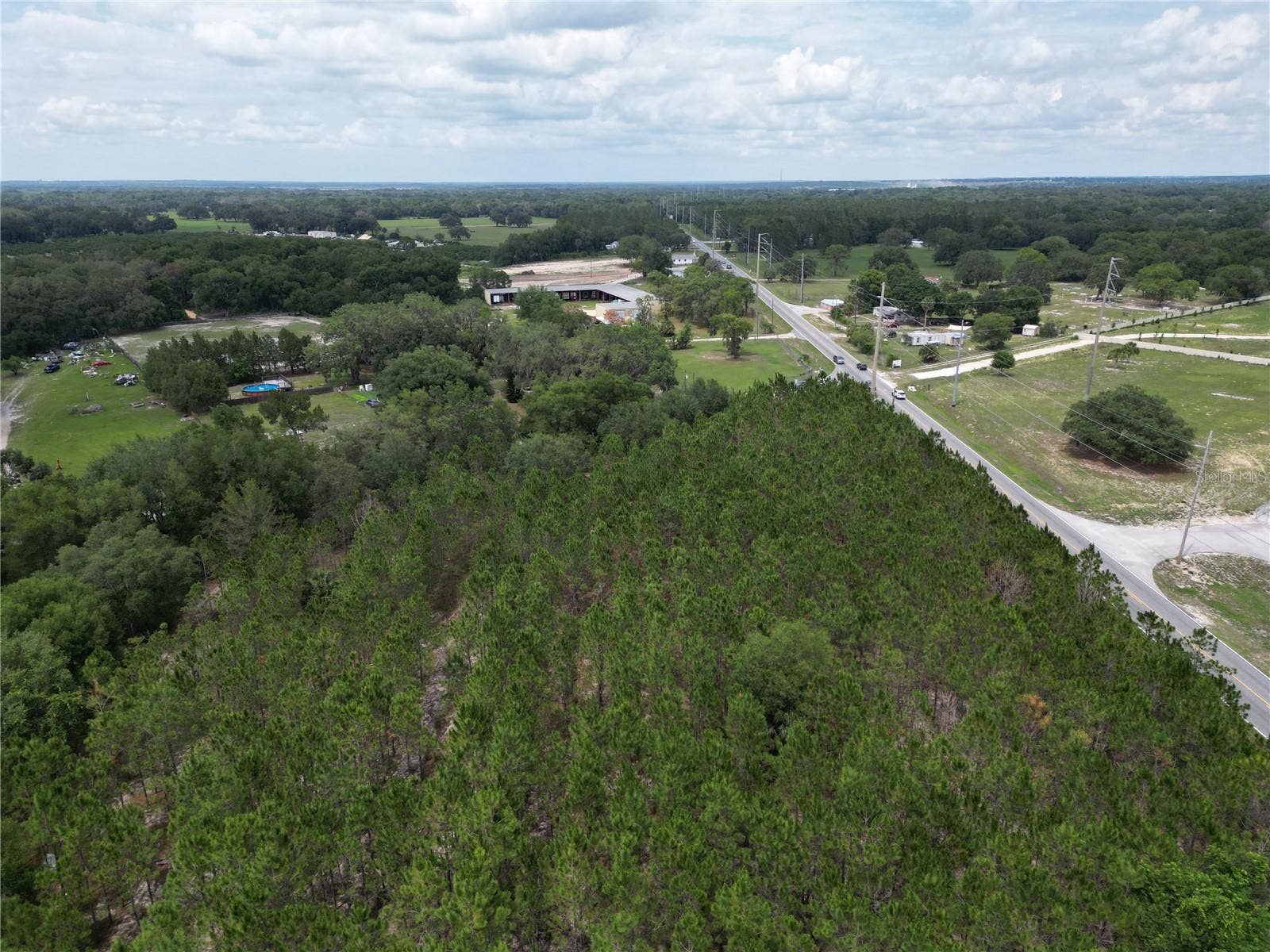 9300 E TREASURE ISLAND AVENUE, Leesburg, FL 34788 An aerial photo of the site from the northeastern corner, oriented northeast.