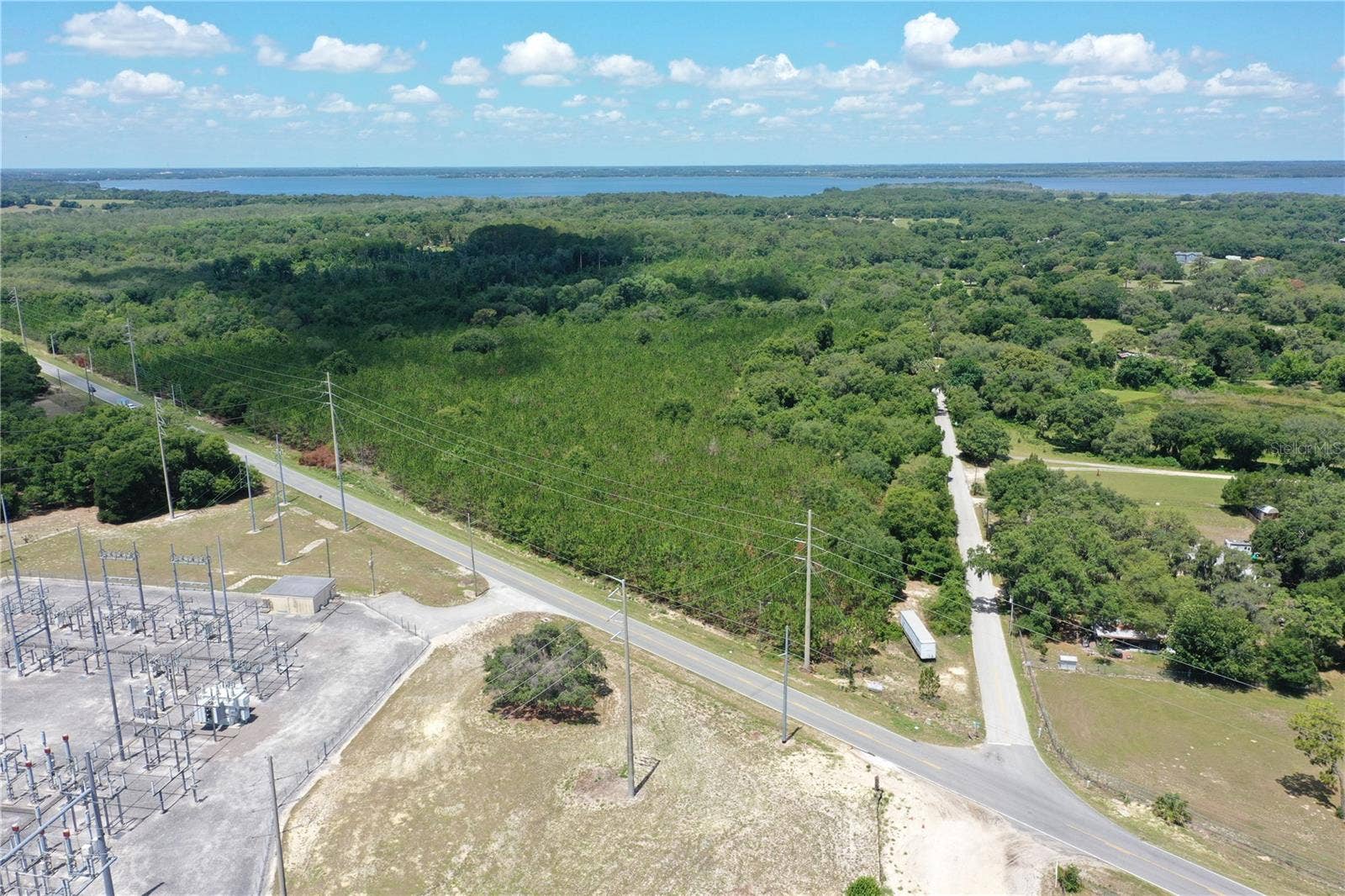 9300 E TREASURE ISLAND AVENUE, Leesburg, FL 34788 An aerial photo of the site from the northeastern corner, oriented southwest.