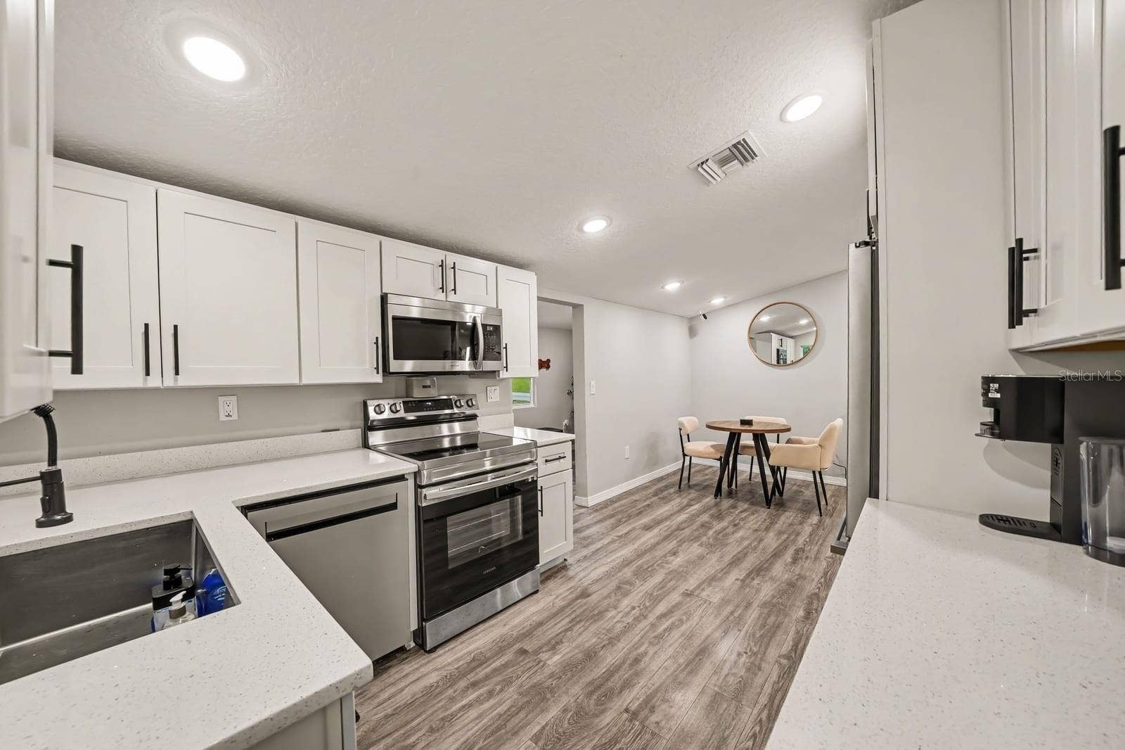 1611 SALMON STREET, St Cloud, FL 34771 Open-Concept Kitchen Flowing Into Bright Dining Area with Natural Light