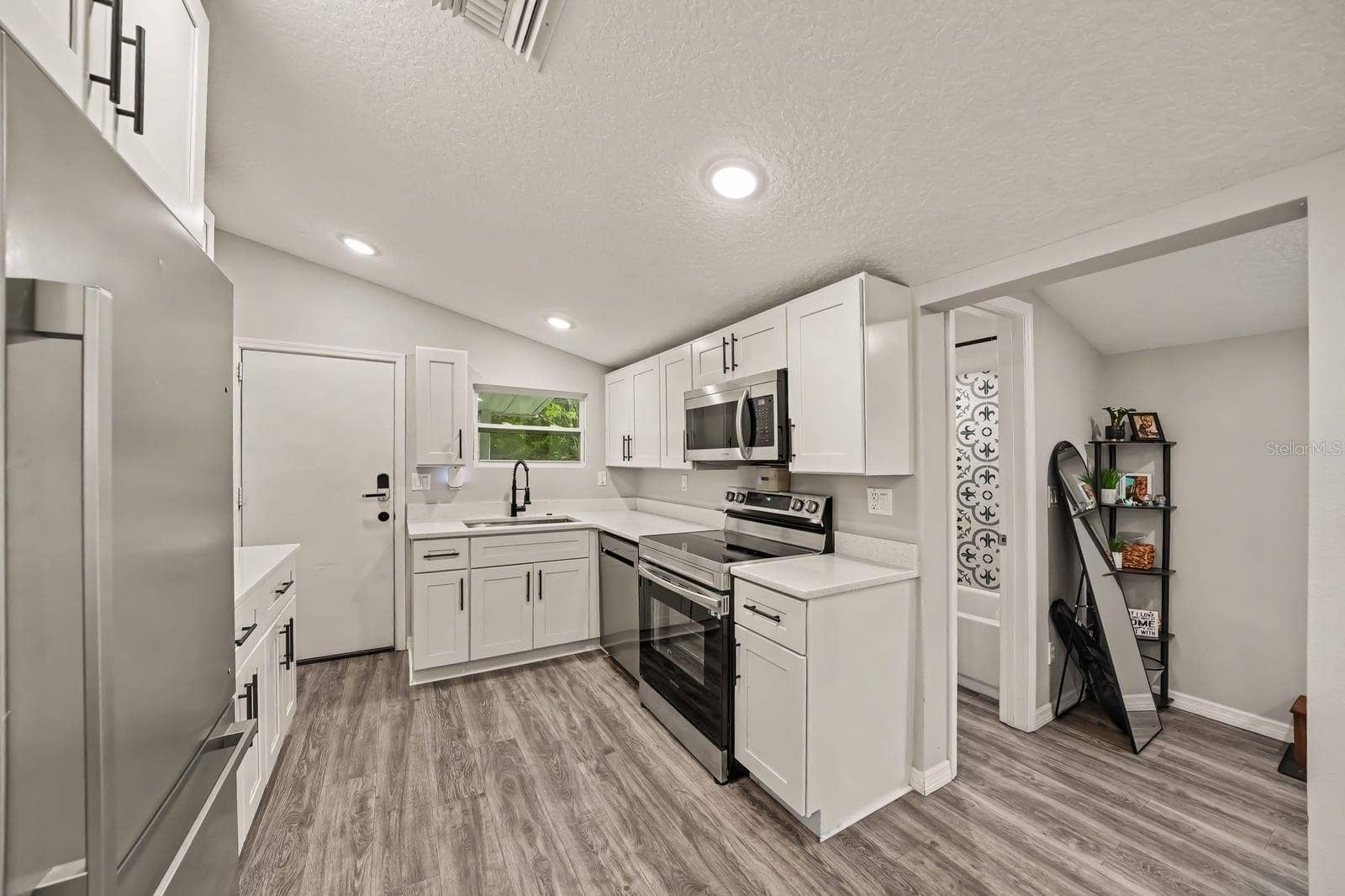 1611 SALMON STREET, St Cloud, FL 34771 Modern Kitchen Layout with Island Seating and Ample Counter Space