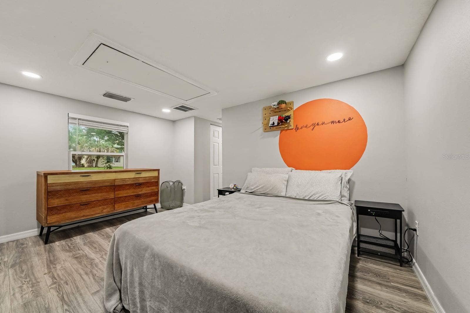 1611 SALMON STREET, St Cloud, FL 34771 Bright Primary Bedroom with Large Window and Mid-Century Furnishings