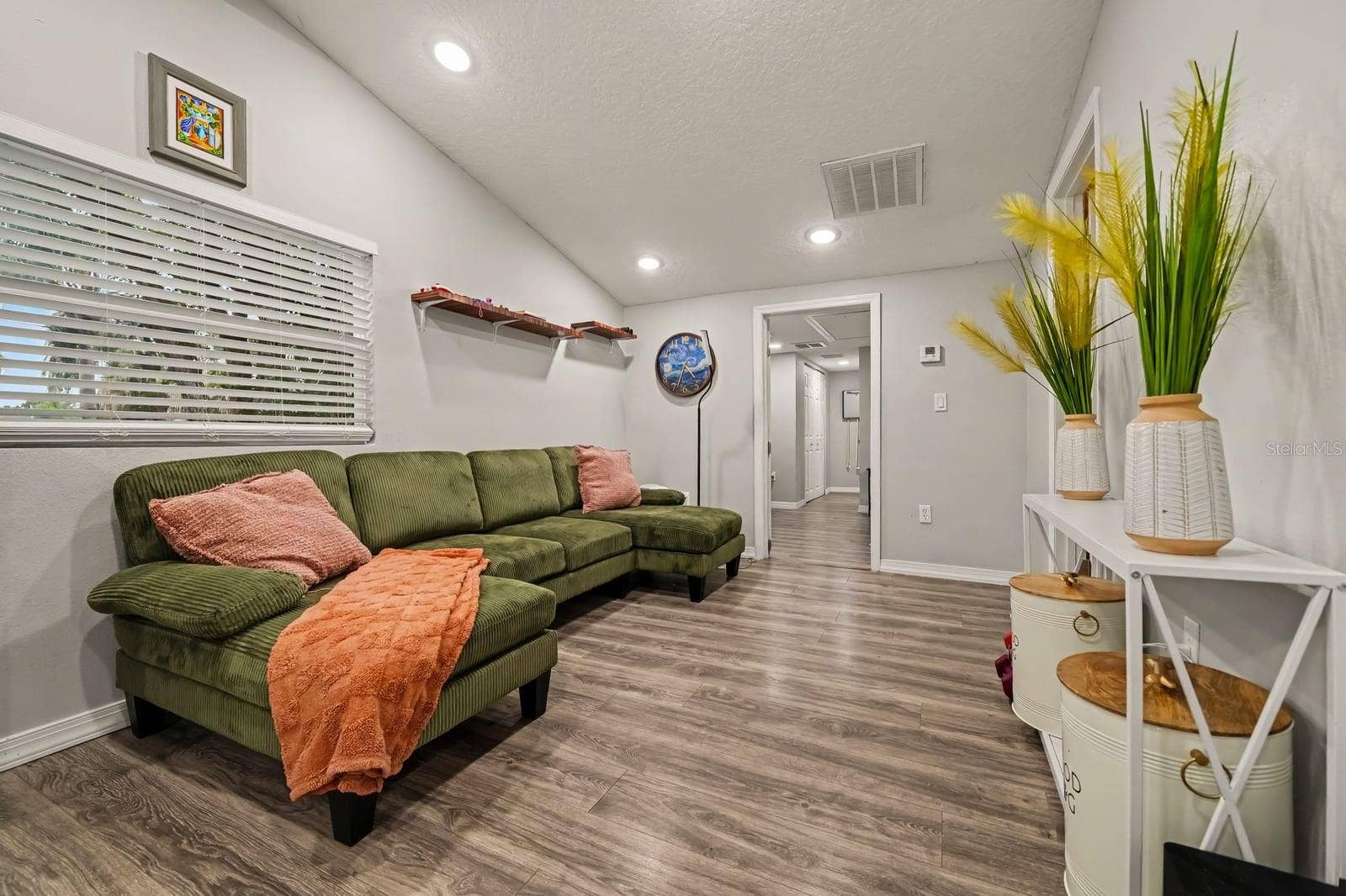 1611 SALMON STREET, St Cloud, FL 34771 Open living area with sectional seating and abundant natural light