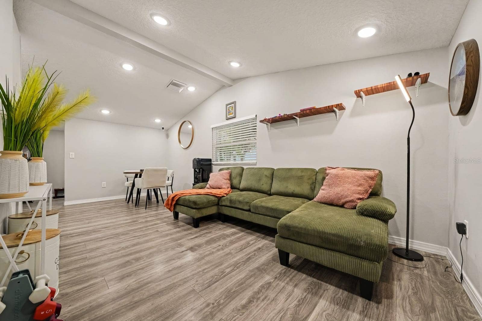 1611 SALMON STREET, St Cloud, FL 34771 Expansive living space with vaulted ceiling and comfortable seating arrangements