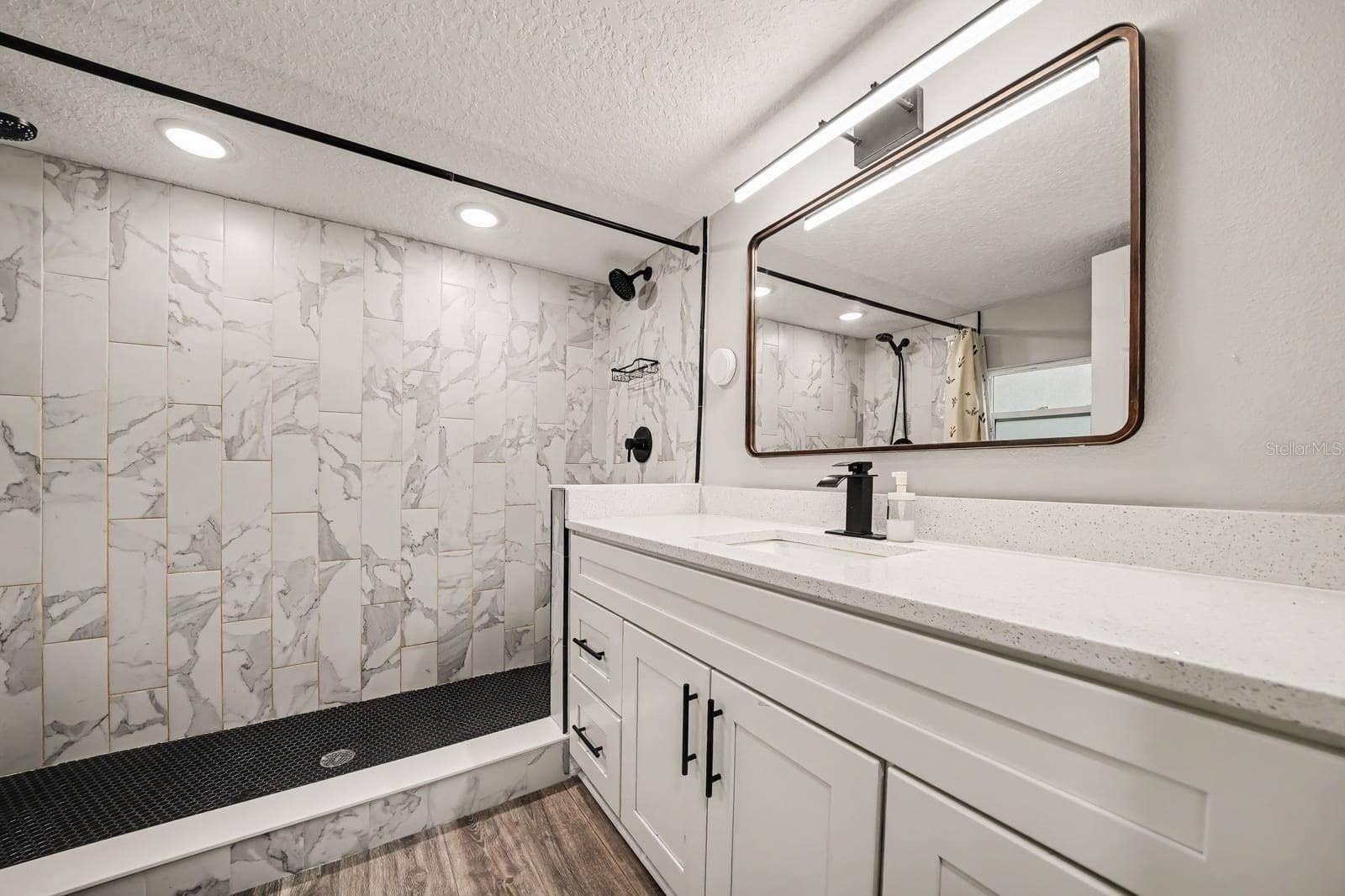 1611 SALMON STREET, St Cloud, FL 34771 Luxe Primary Bath with Marble Tile Shower and Dual-Sink Vanity