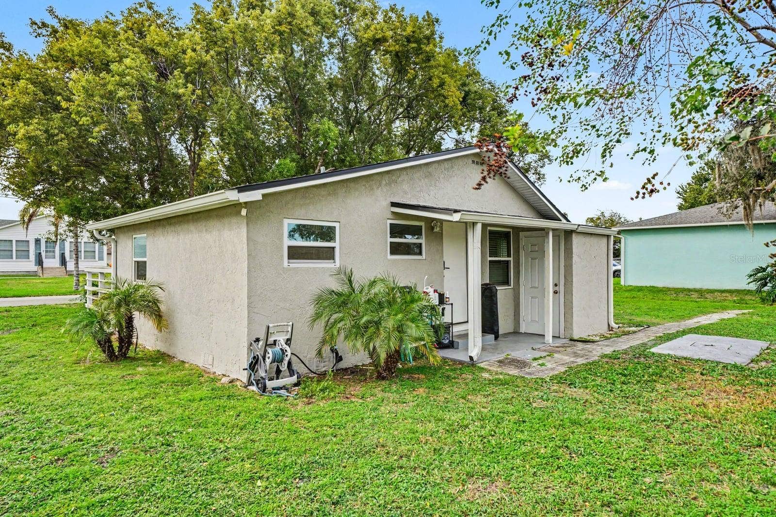 1611 SALMON STREET, St Cloud, FL 34771 Welcoming entrance features covered porch area and lush tropical plantings
