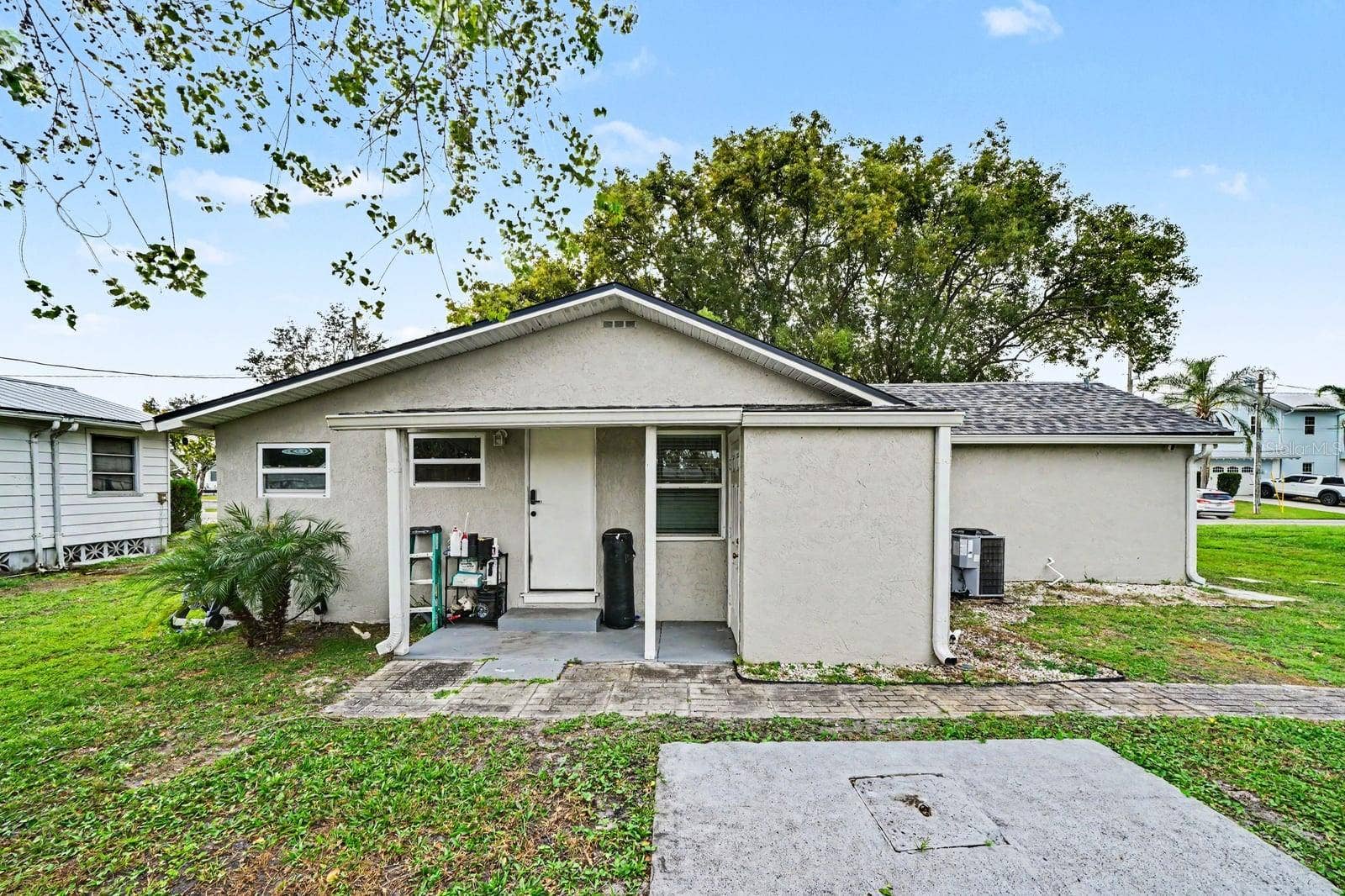 1611 SALMON STREET, St Cloud, FL 34771 Charming single-story home with covered front porch and mature landscaping