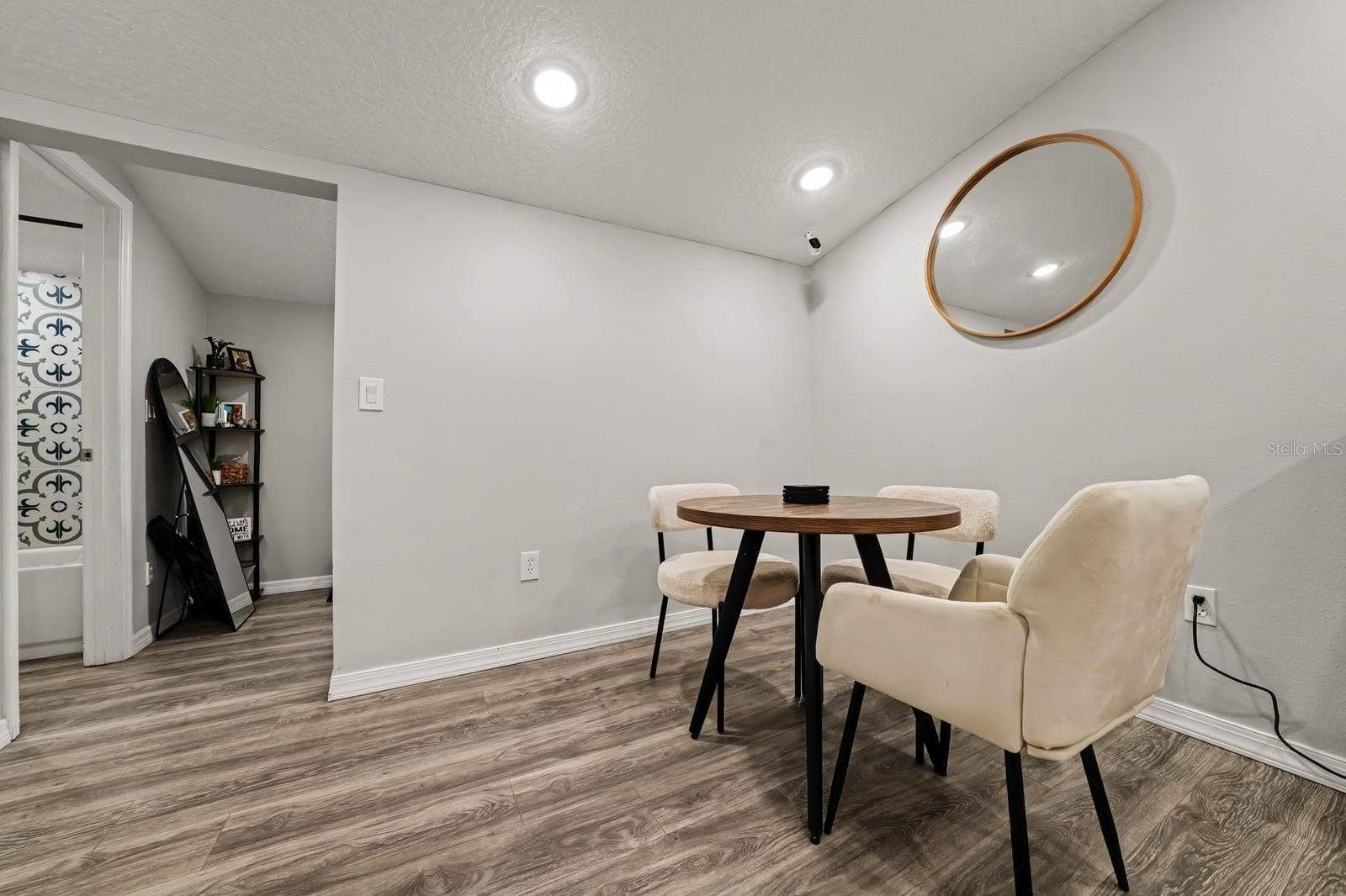 1611 SALMON STREET, St Cloud, FL 34771 Versatile Dining Space with Mid-Century Table and Accent Wall Mirror