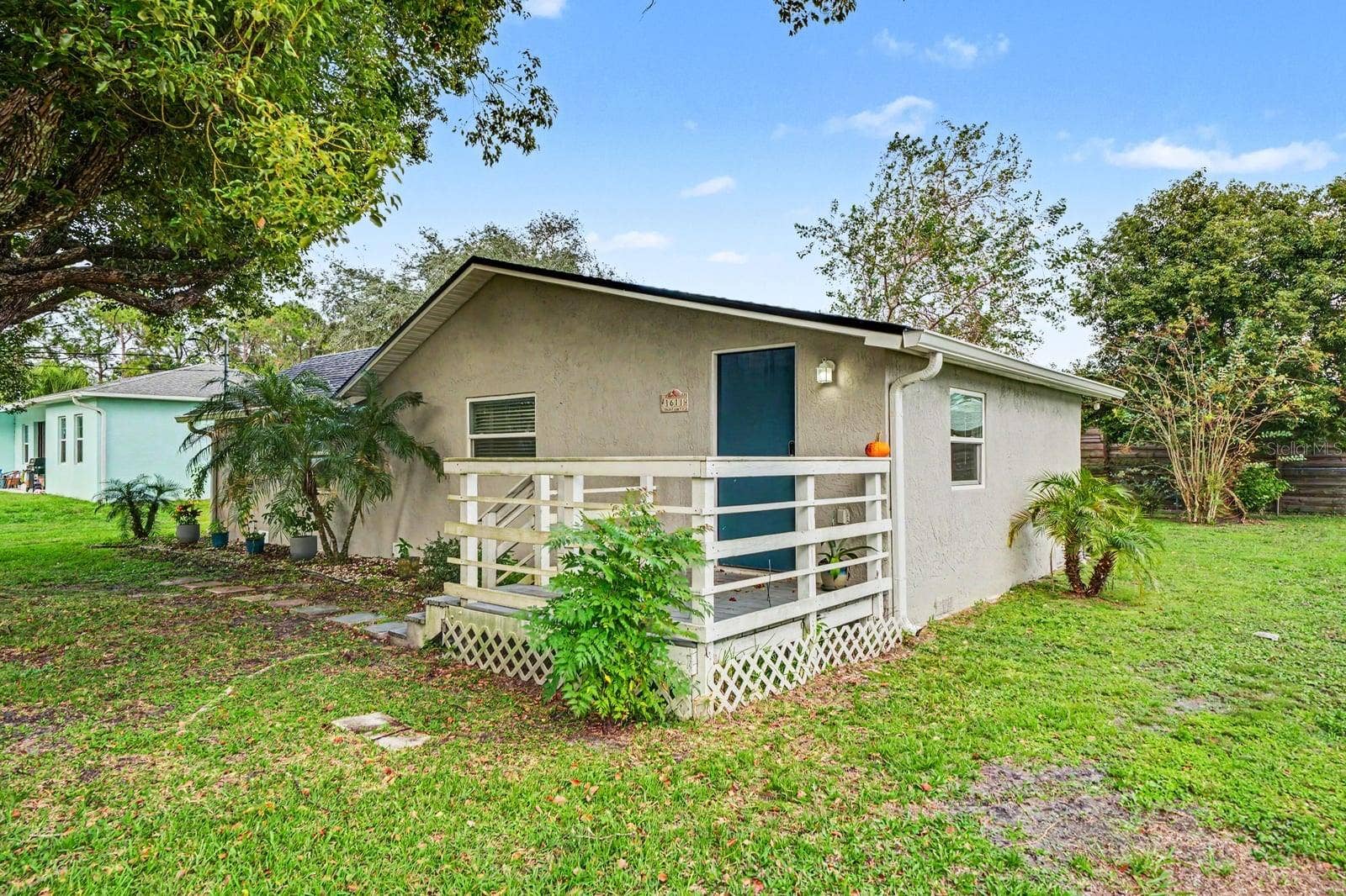 1611 SALMON STREET, St Cloud, FL 34771 Front Elevation with Mature Oak Tree & Welcoming Entry Porch