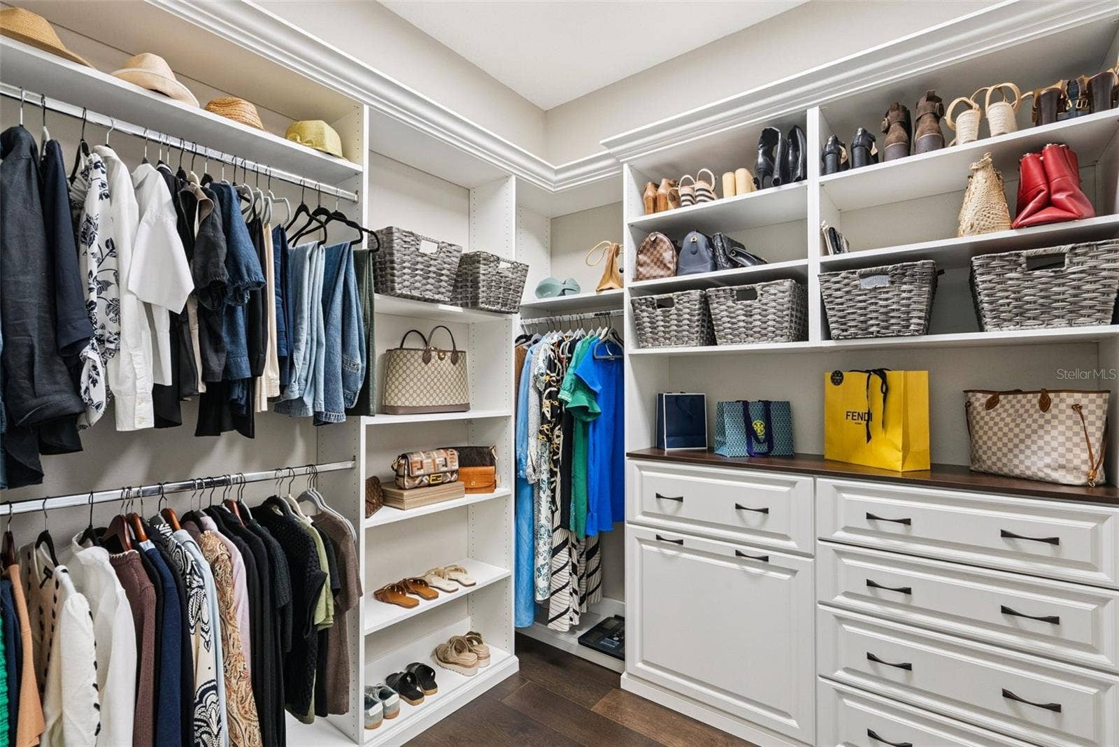 Walk-in owners suite w/ custom closet system by Closets by Design