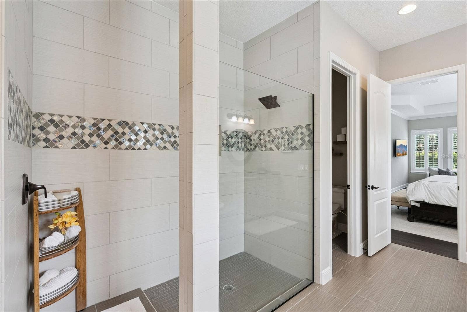 Owners bathroom with dual vanities, a soaking tub, spacious walk-in shower