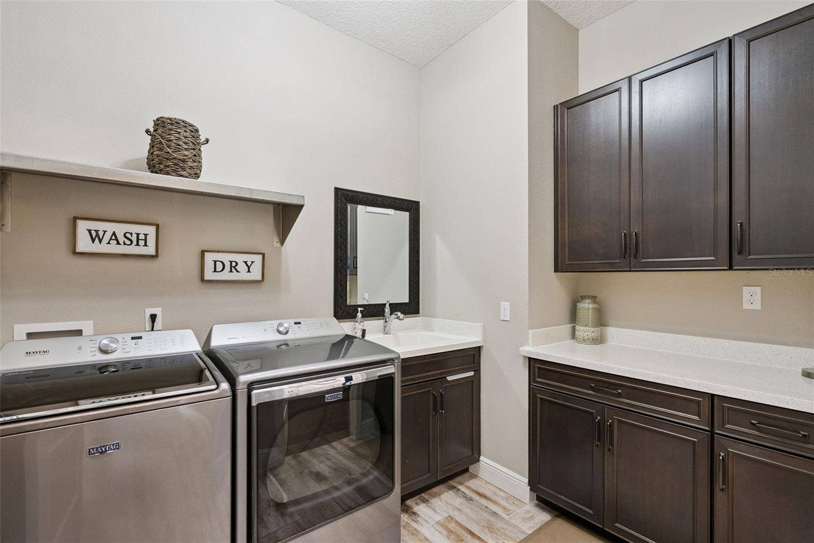 Laundry room w/storage accessible to the owners suite closet and hallway