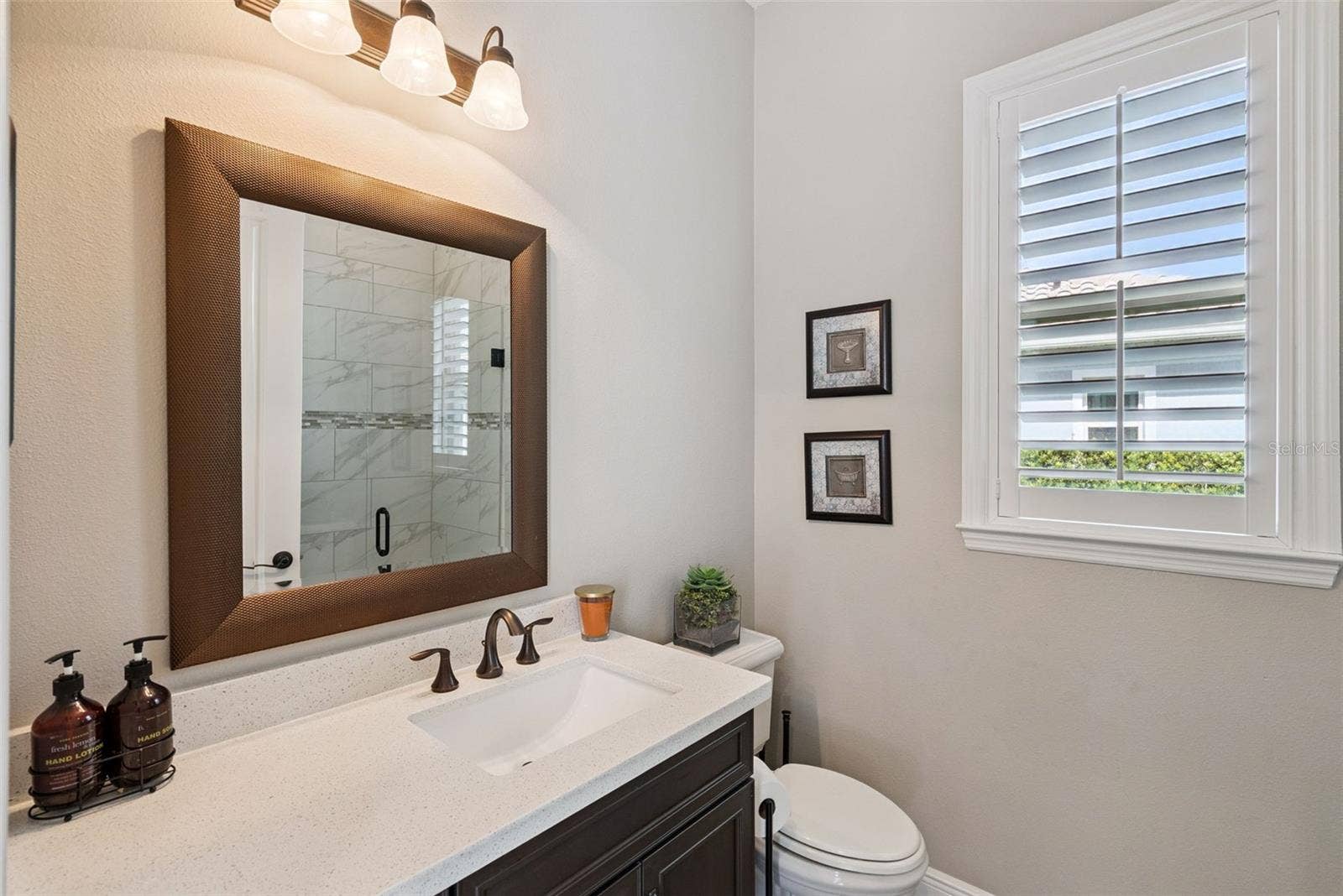 Pool bathroom off kitchen near screened-in, covered lanai