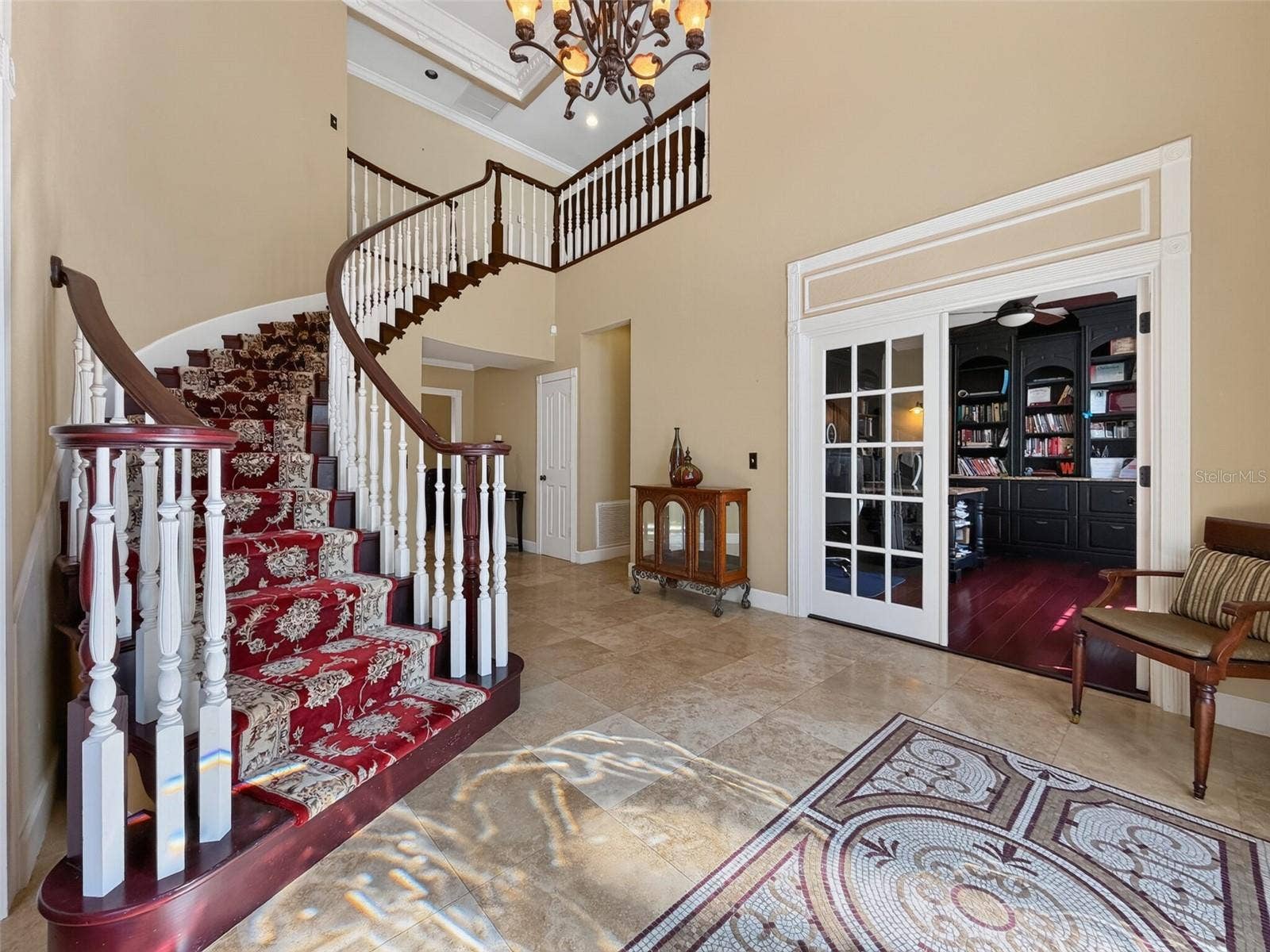 Foyer with volume ceilings and crown molding