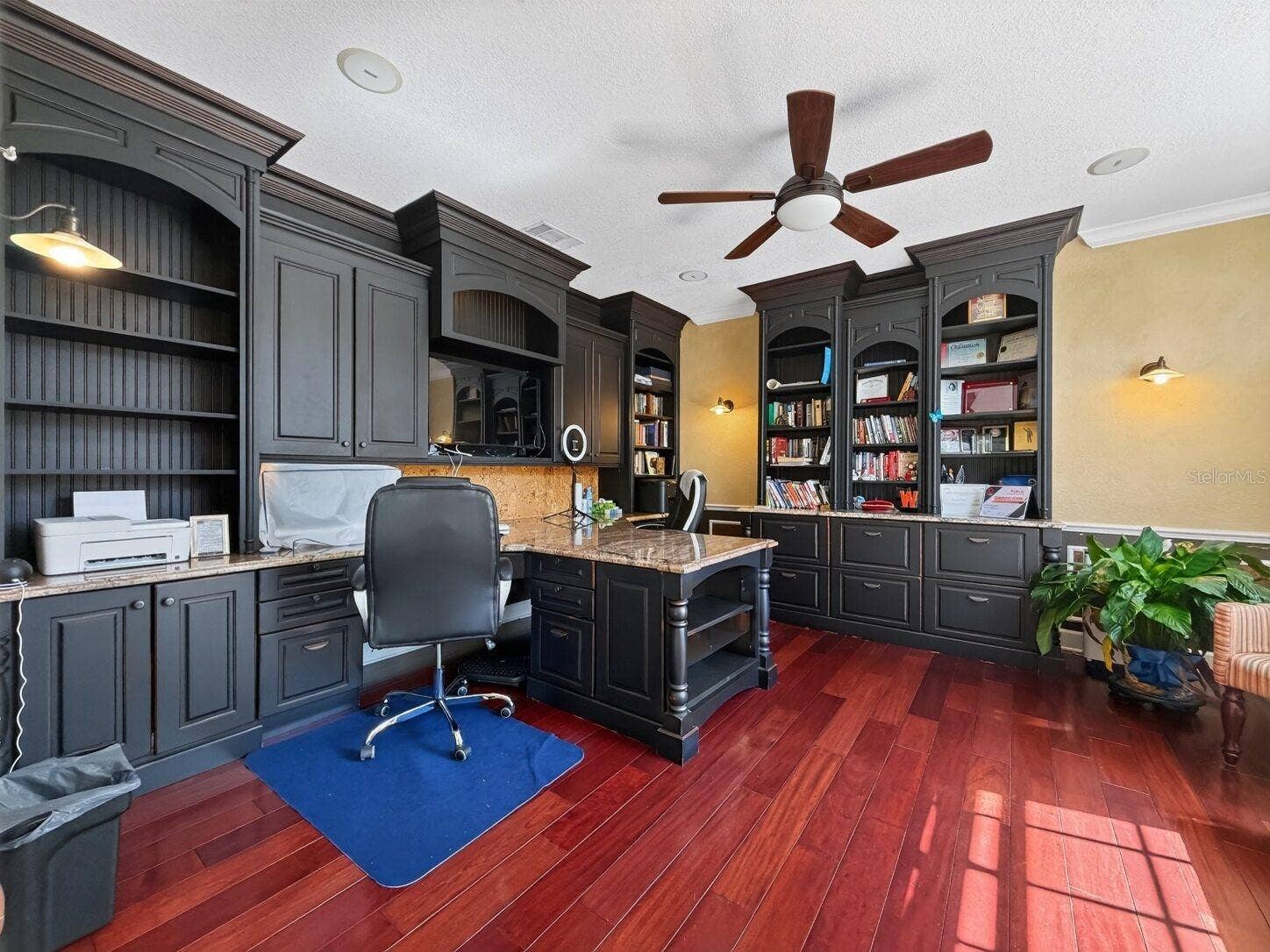 Two-person office with built-in cabinetry and bookshelves