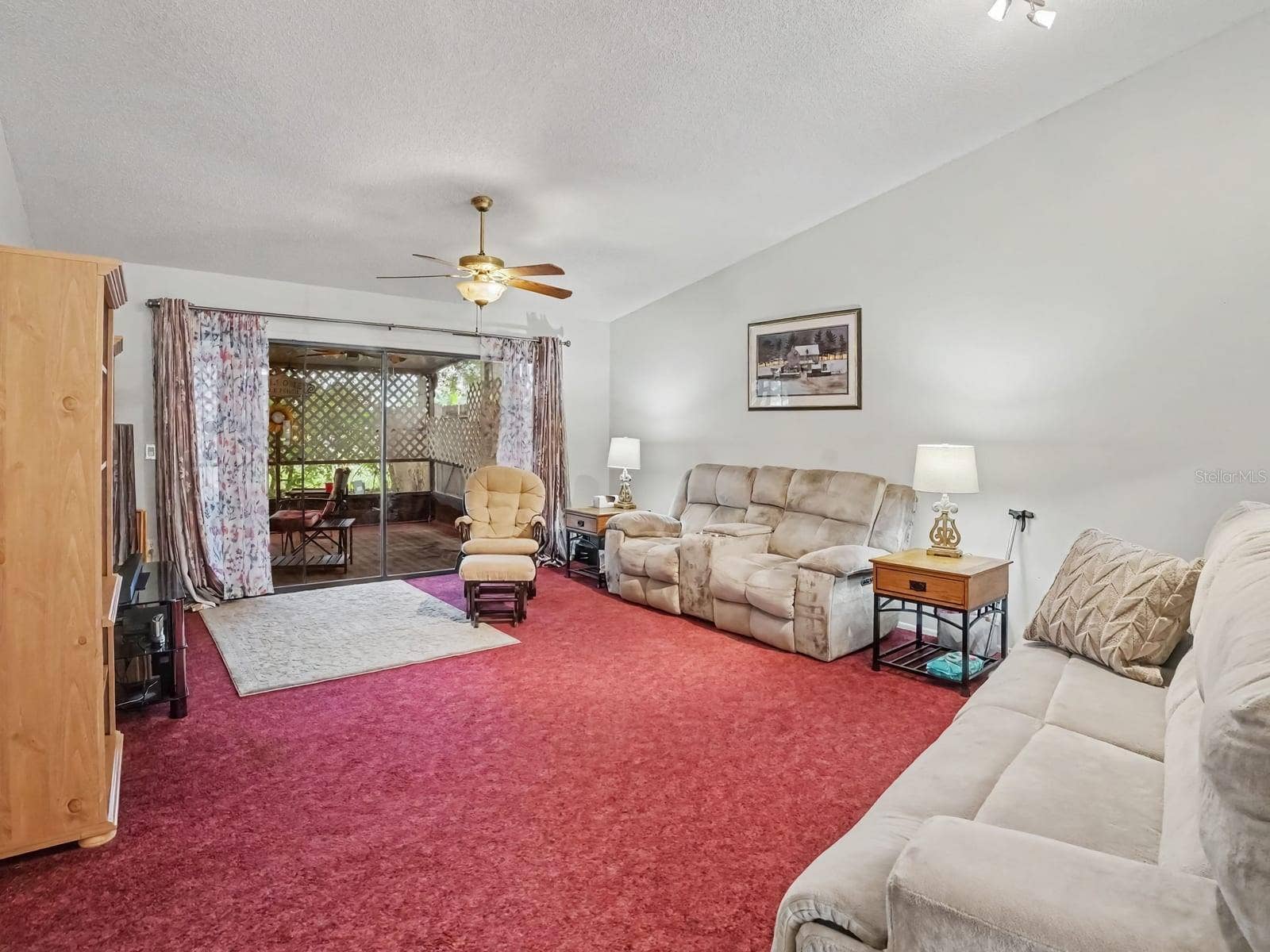 Expansive living room with sliding glass doors to covered patio
