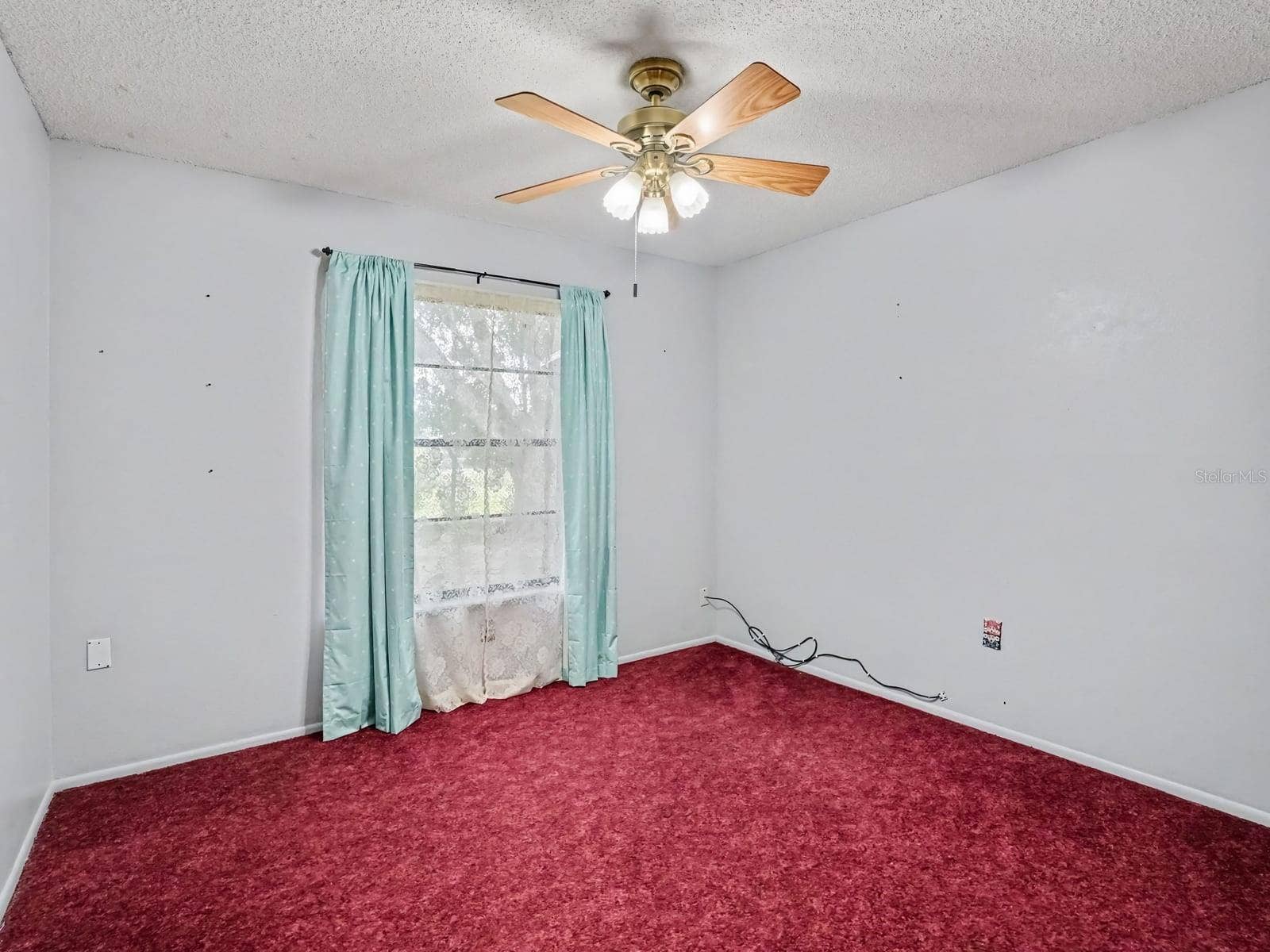 Spacious Secondary Bedroom with Large Window and Ceiling Fan