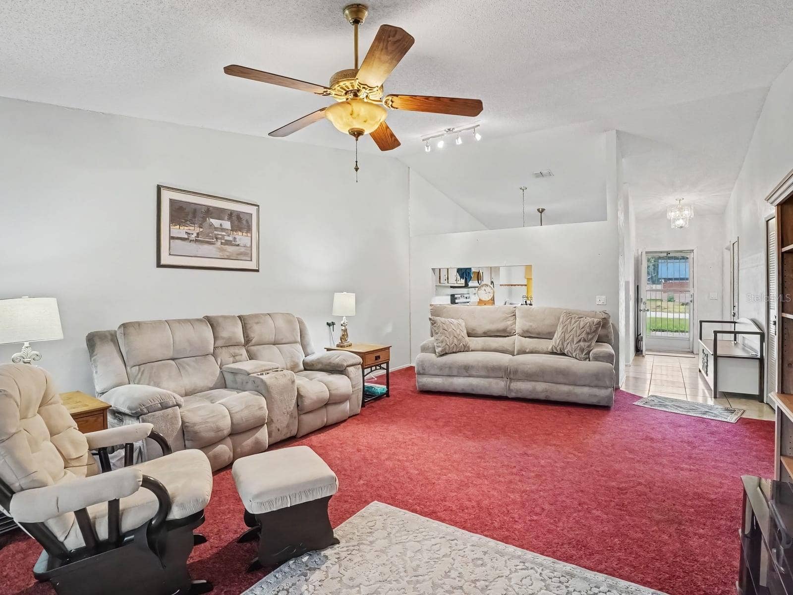 Open-concept living space with multiple seating areas & high ceilings