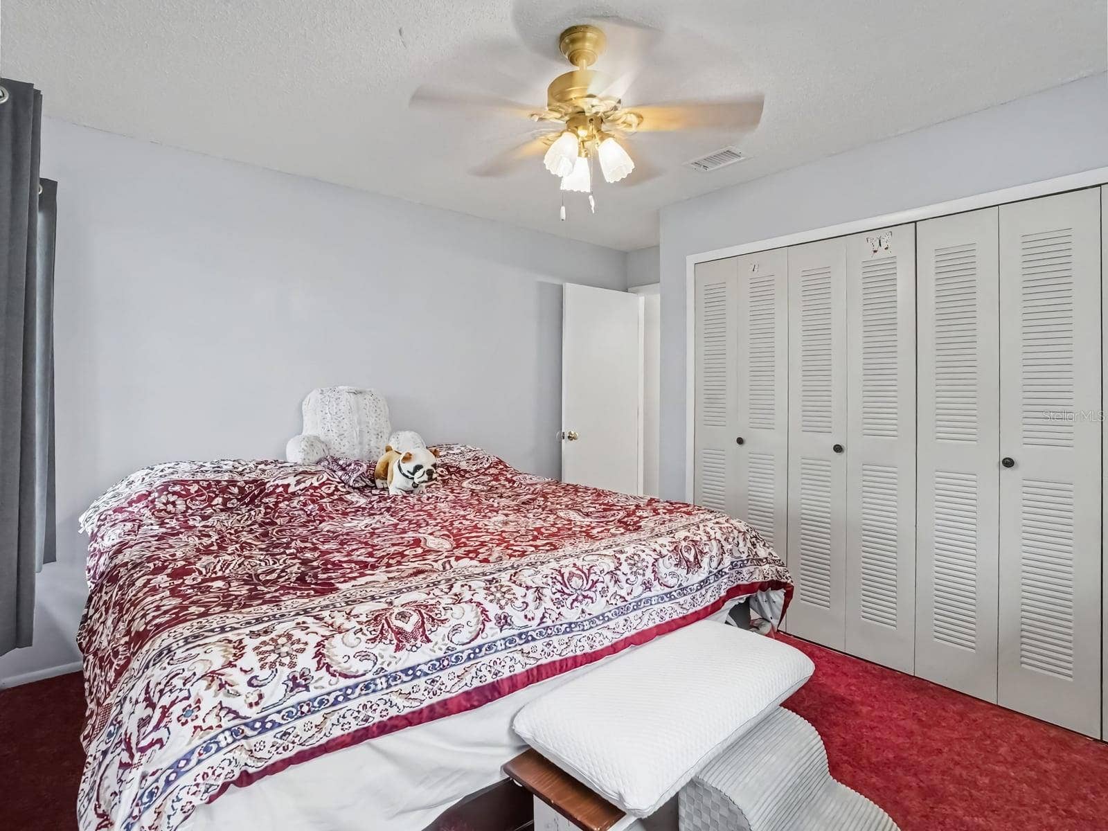 Bedroom with Built-In Closet Storage and Ceiling Fan