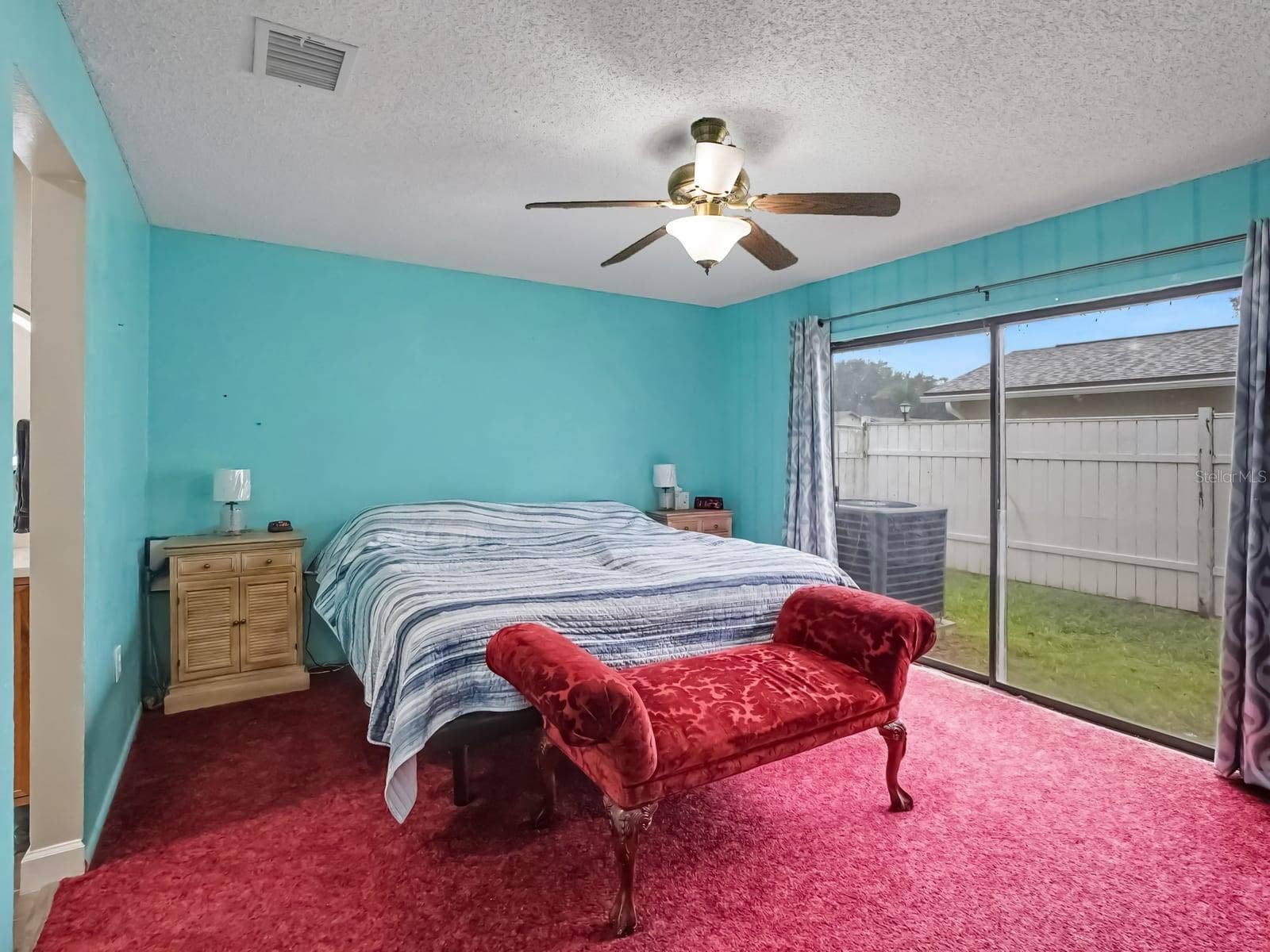 Bright Master Suite with Sliding Glass Doors to Backyard