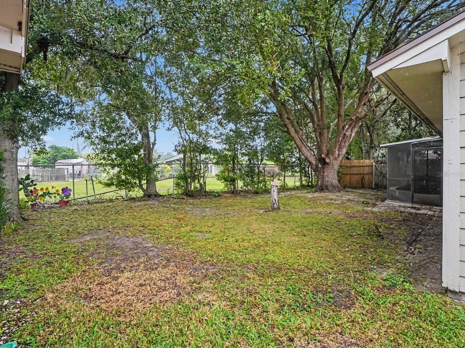 Mature Trees Provide Shade & Privacy in Spacious Fenced Backyard Oasis