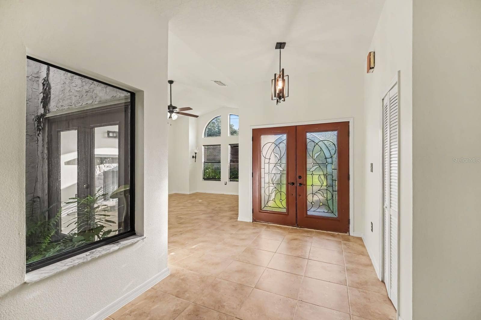 5560 BOB WHITE TRAIL, Mims, FL 32754 Bright entryway with decorative glass doors and open ceiling layout