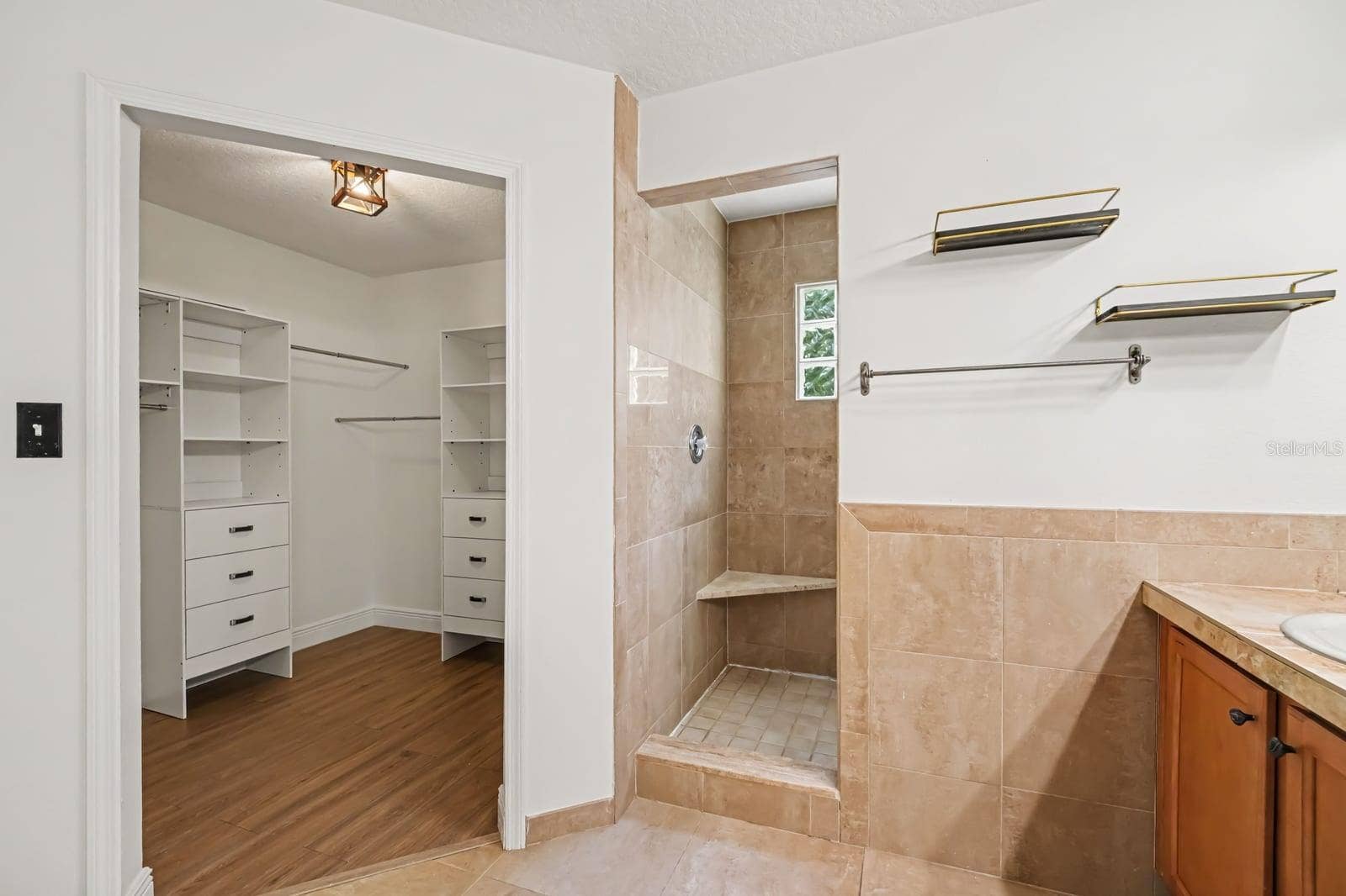 5560 BOB WHITE TRAIL, Mims, FL 32754 Walk-In Shower with Glass Block Window, Tile Surround, and Built-In Shelf