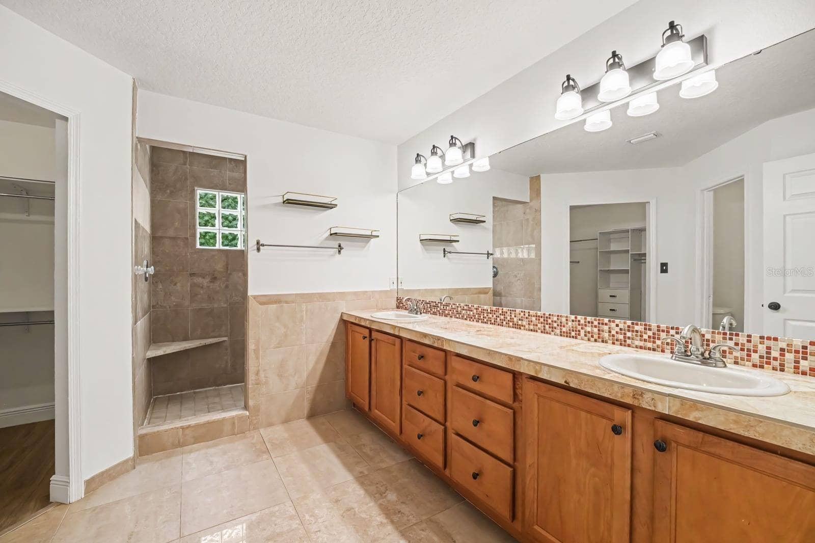 5560 BOB WHITE TRAIL, Mims, FL 32754 Master Bath with Double Vanity, Tile Accents, and Walk-In Shower
