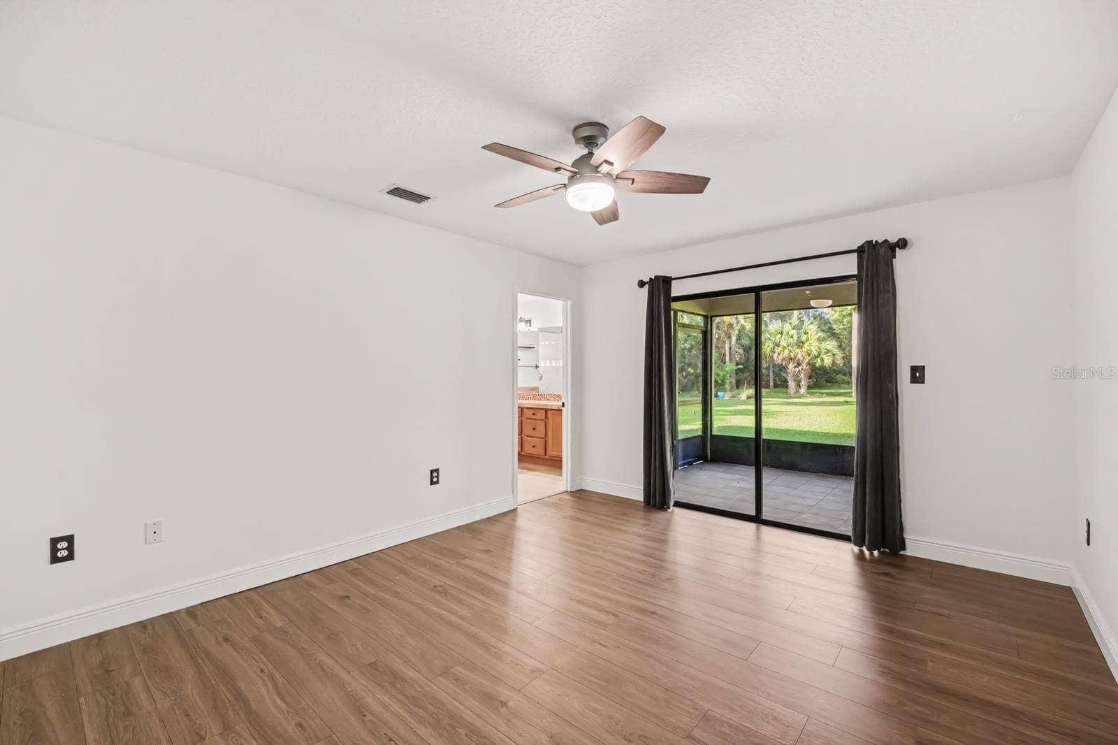 5560 BOB WHITE TRAIL, Mims, FL 32754 Master Suite With Hardwood Floors, Ceiling Fan & Sliding Glass Door To Patio