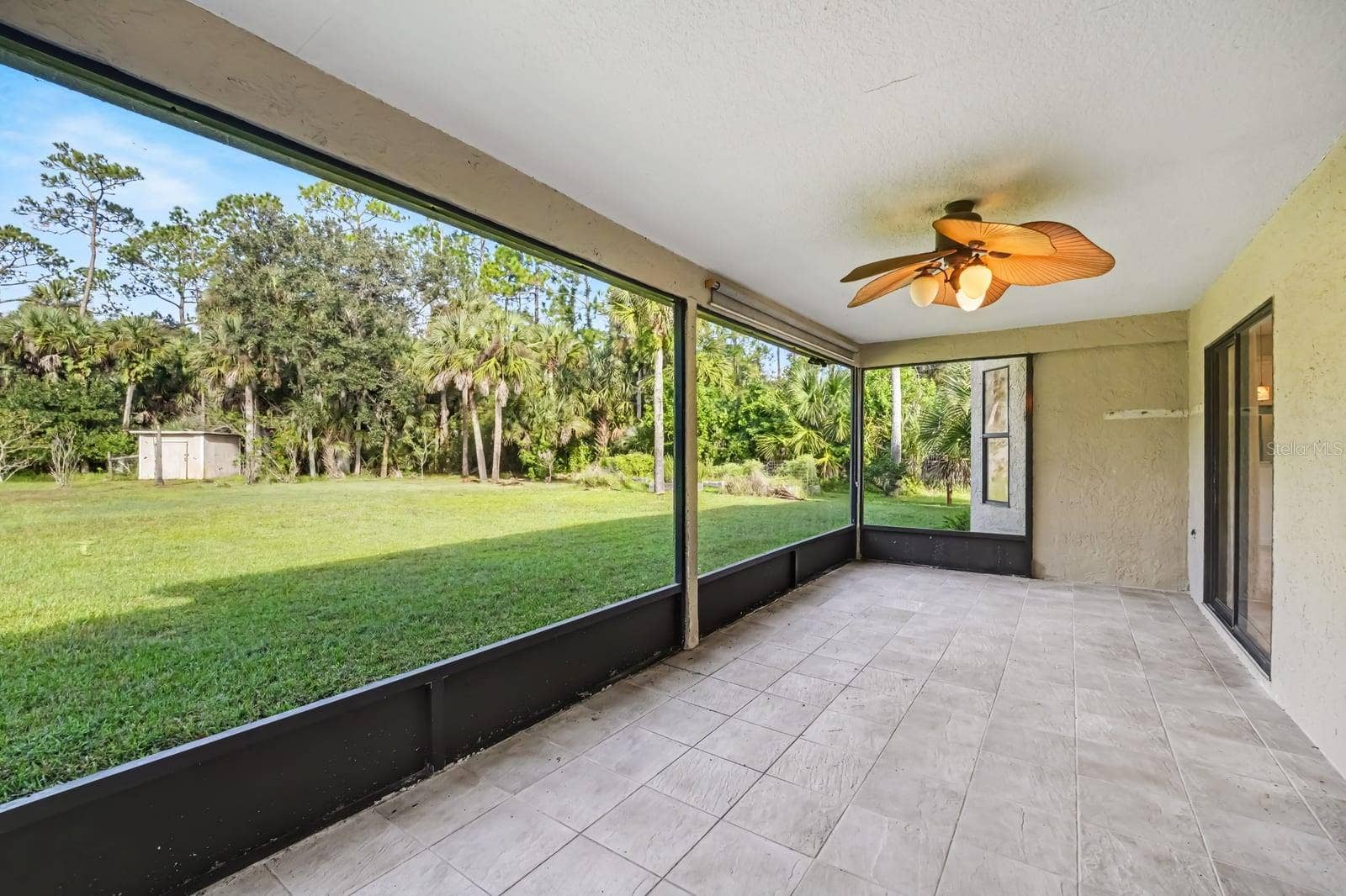 5560 BOB WHITE TRAIL, Mims, FL 32754 Screened Lanai With Tile Flooring & Expansive Lawn Views