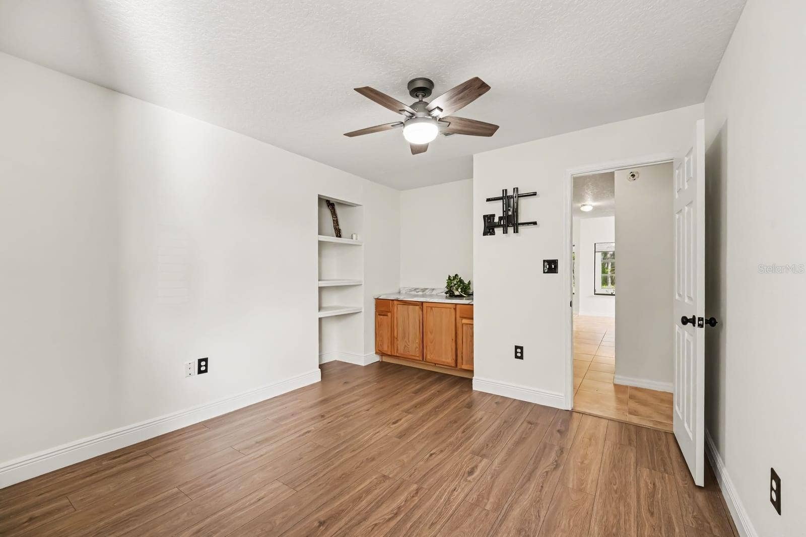 5560 BOB WHITE TRAIL, Mims, FL 32754 Secondary Bedroom with Ceiling Fan, Built-In Shelving, and Wood Flooring