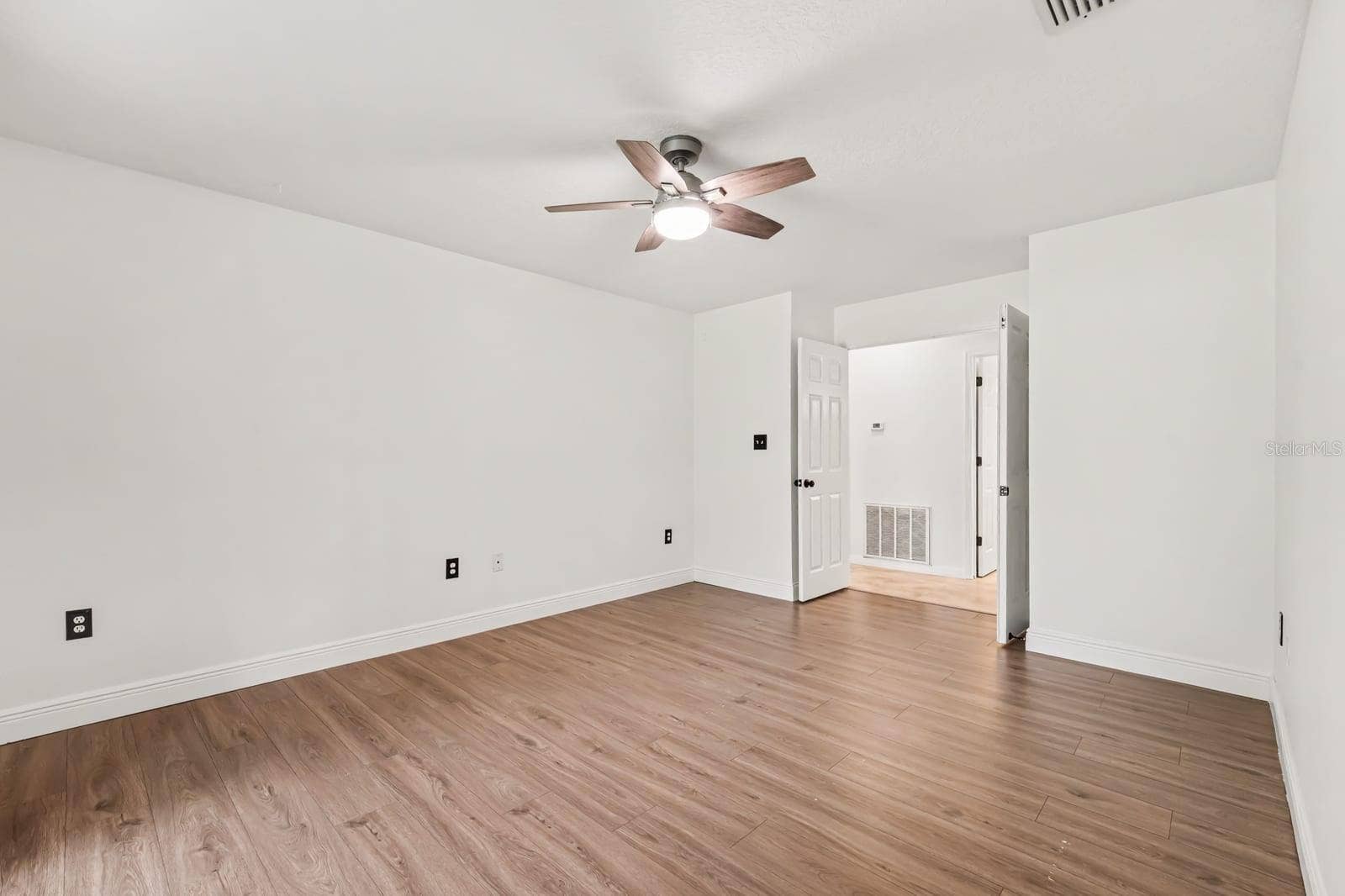 5560 BOB WHITE TRAIL, Mims, FL 32754 Spacious Bedroom with Ceiling Fan and Neutral Flooring Throughout