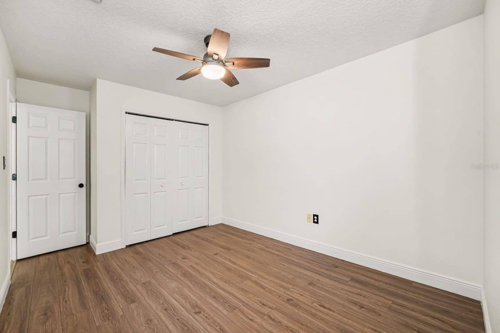 5560 BOB WHITE TRAIL, Mims, FL 32754 Master Bedroom With Double Closets, Ceiling Fan, and Hard Flooring