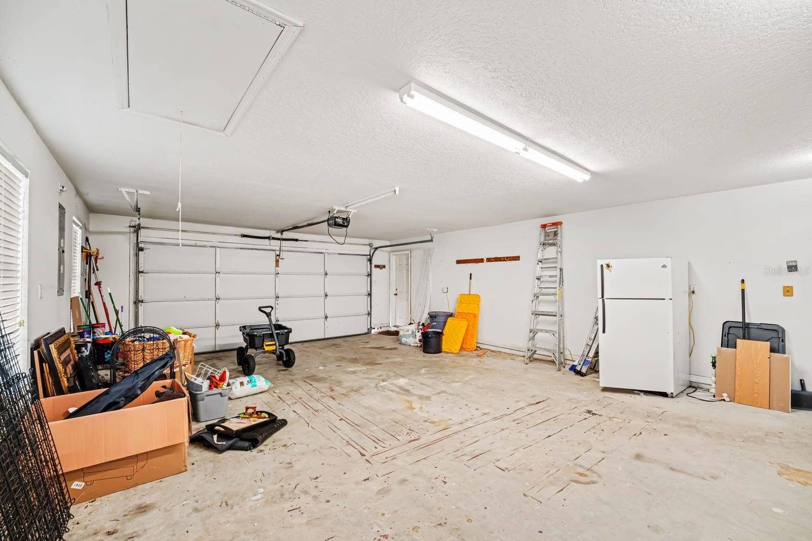 5560 BOB WHITE TRAIL, Mims, FL 32754 Spacious Two-Car Garage With Storage and Overhead Lighting