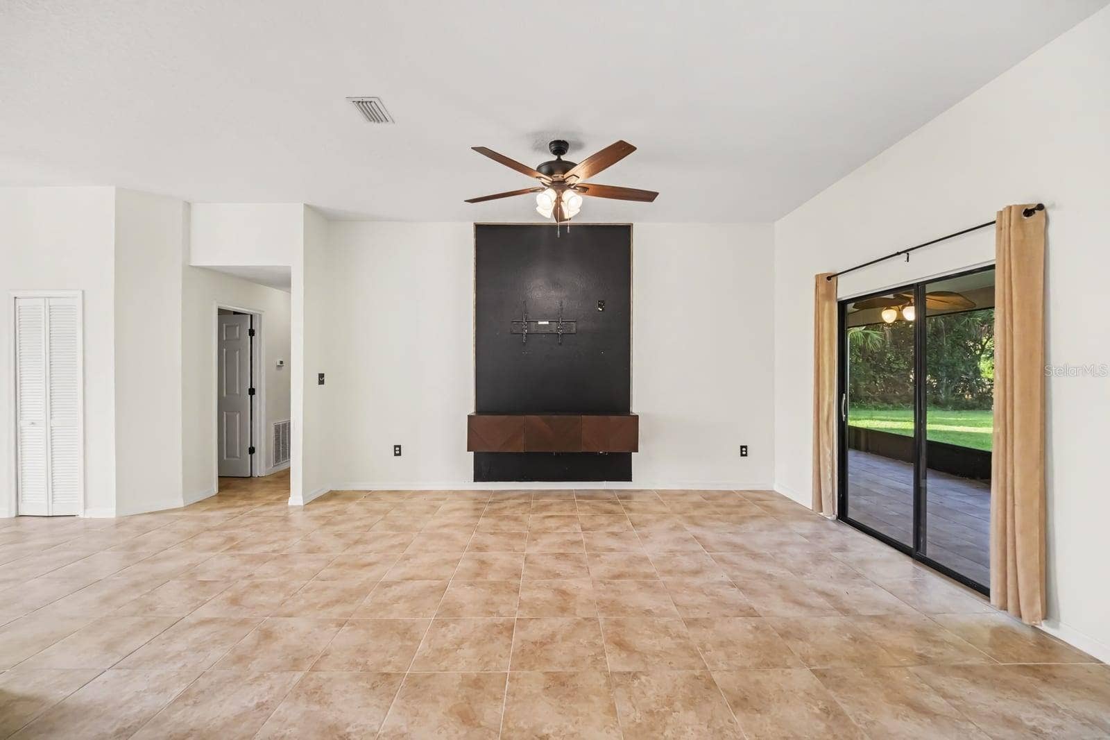 5560 BOB WHITE TRAIL, Mims, FL 32754 Spacious Great Room With Tile Flooring, Built-In Entertainment Center & Sliding Glass Doors