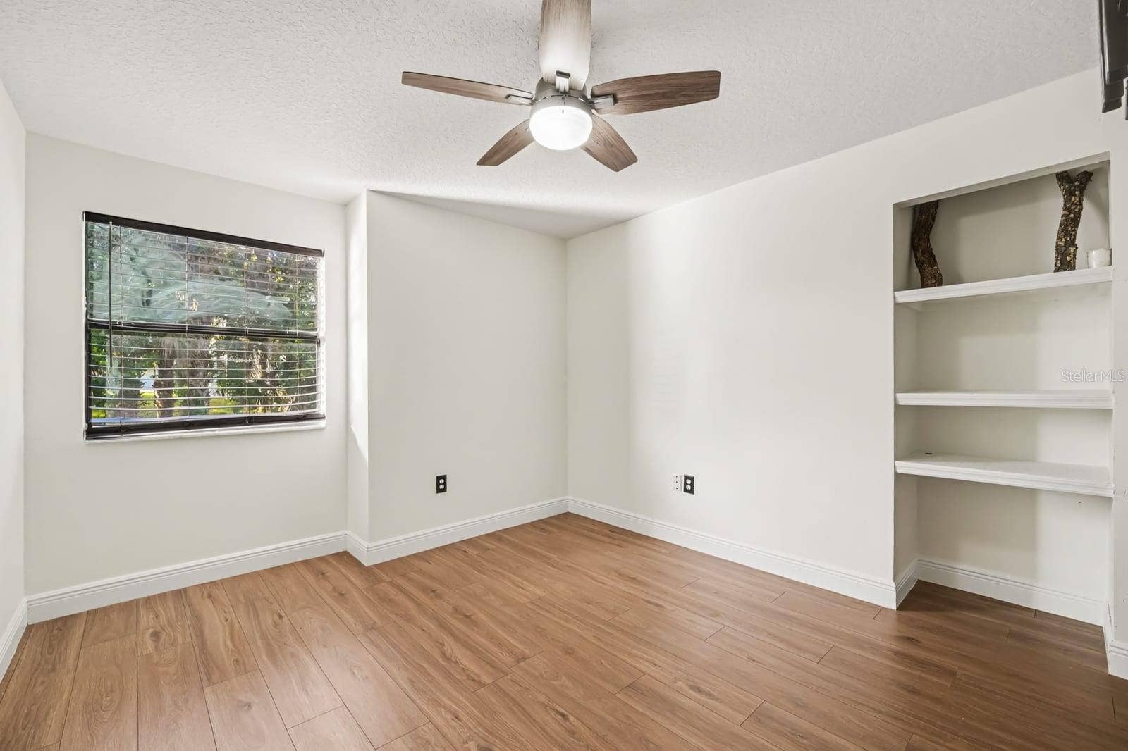 5560 BOB WHITE TRAIL, Mims, FL 32754 Bright Bedroom with Ceiling Fan, Built-In Shelving, and Window Views