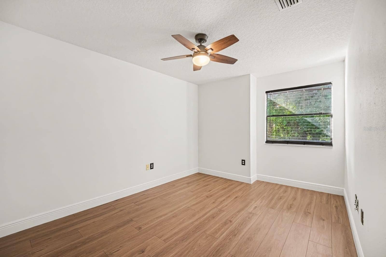 5560 BOB WHITE TRAIL, Mims, FL 32754 Bright Secondary Bedroom With Hard Flooring, Ceiling Fan, and Large Window