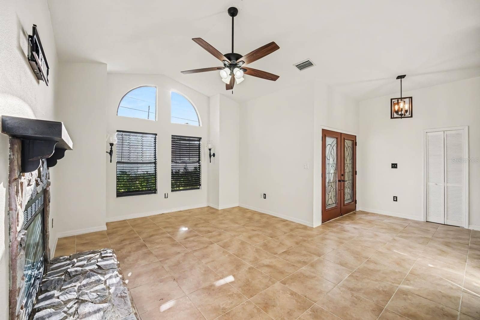 5560 BOB WHITE TRAIL, Mims, FL 32754 Living room flows to entry with architectural arch details and views
