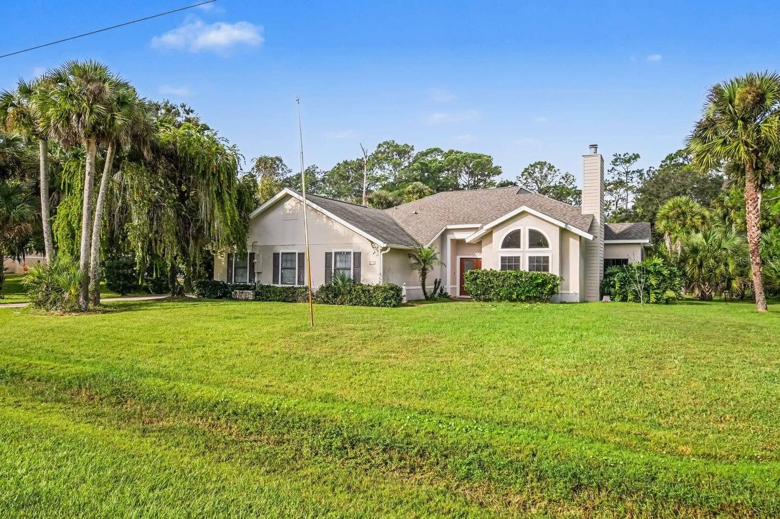 5560 BOB WHITE TRAIL, Mims, FL 32754 Elegant single-story residence nestled among native Florida landscape