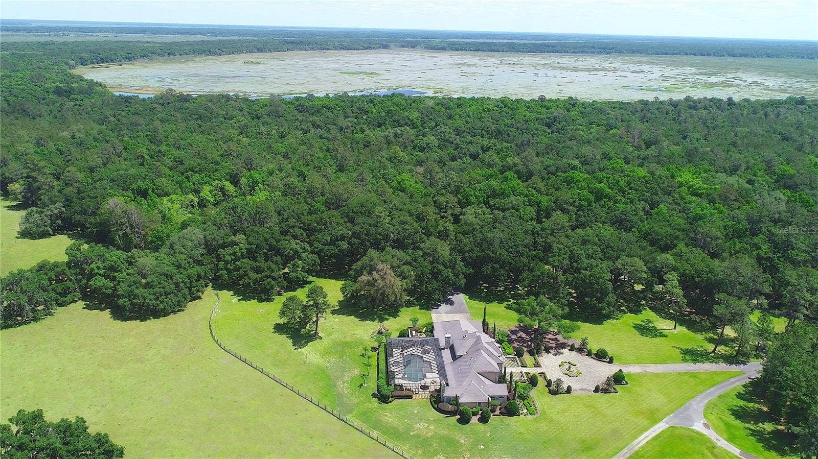 15305 NW HWY 320, Micanopy, FL 32667 Aerial showing house and lake