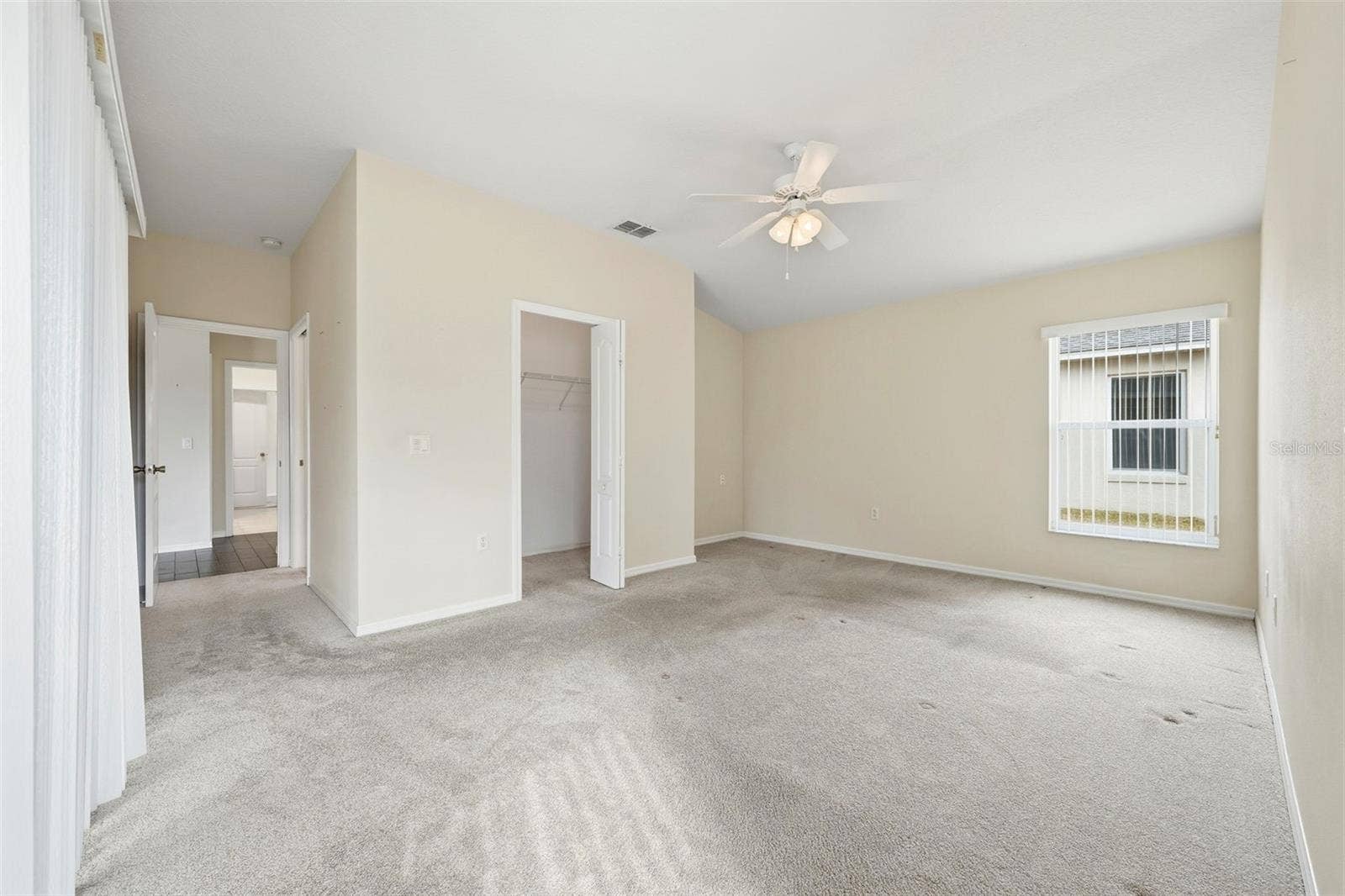 2311 N ANDREA POINT, Lecanto, FL 34461 Primary Bedroom with walk-in closet and sliding doors to lanai