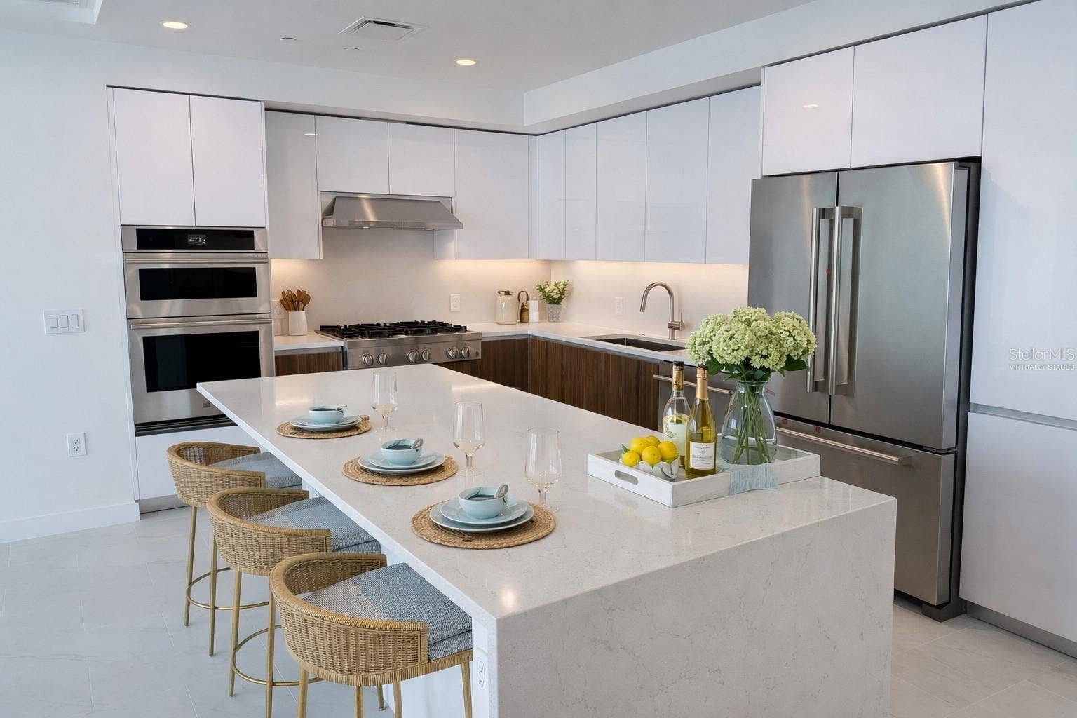 400 CENTRAL AVENUE, #2603, St Petersburg, FL 33701 Waterfall Quartz Island / Breakfast Bar / Kitchen with Stainless Steel Jenn Air Appliances - Virtually Staged