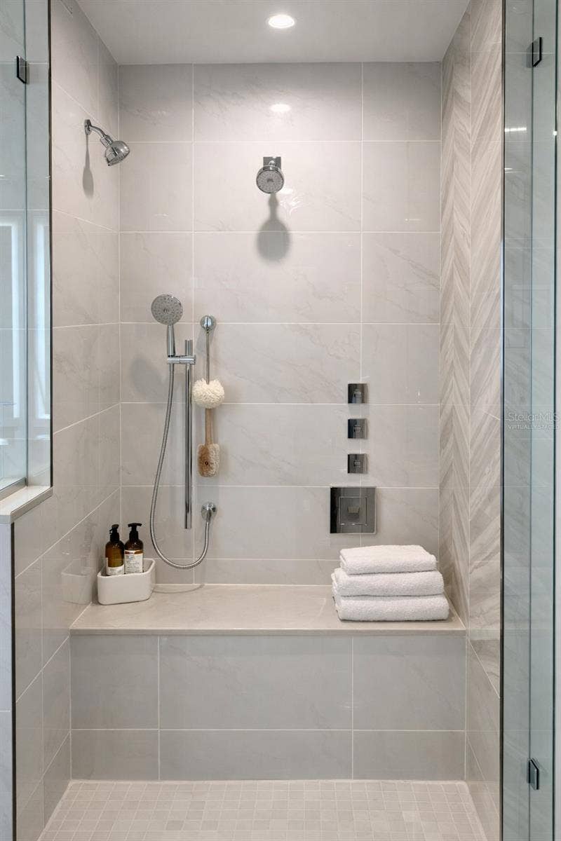 400 CENTRAL AVENUE, #2603, St Petersburg, FL 33701 Owner Bathroom Large Frameless Glass Shower with 2 Rain Heads / 2 Additional Shower Heads and 2 Tiled Benches - Virtually Staged