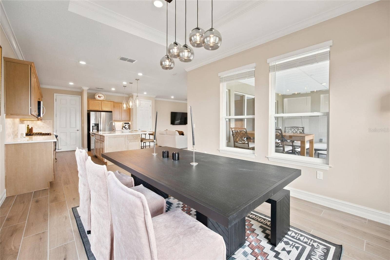 Dining area with decorative lighting and an open connection to the kitchen.