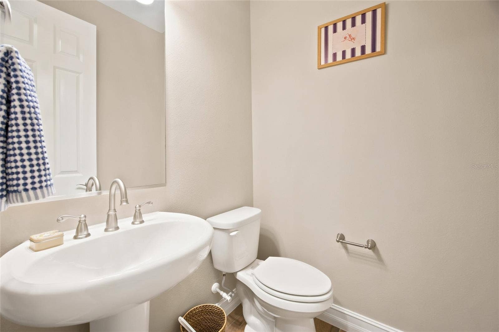 Convenient half bathroom with pedestal sink.