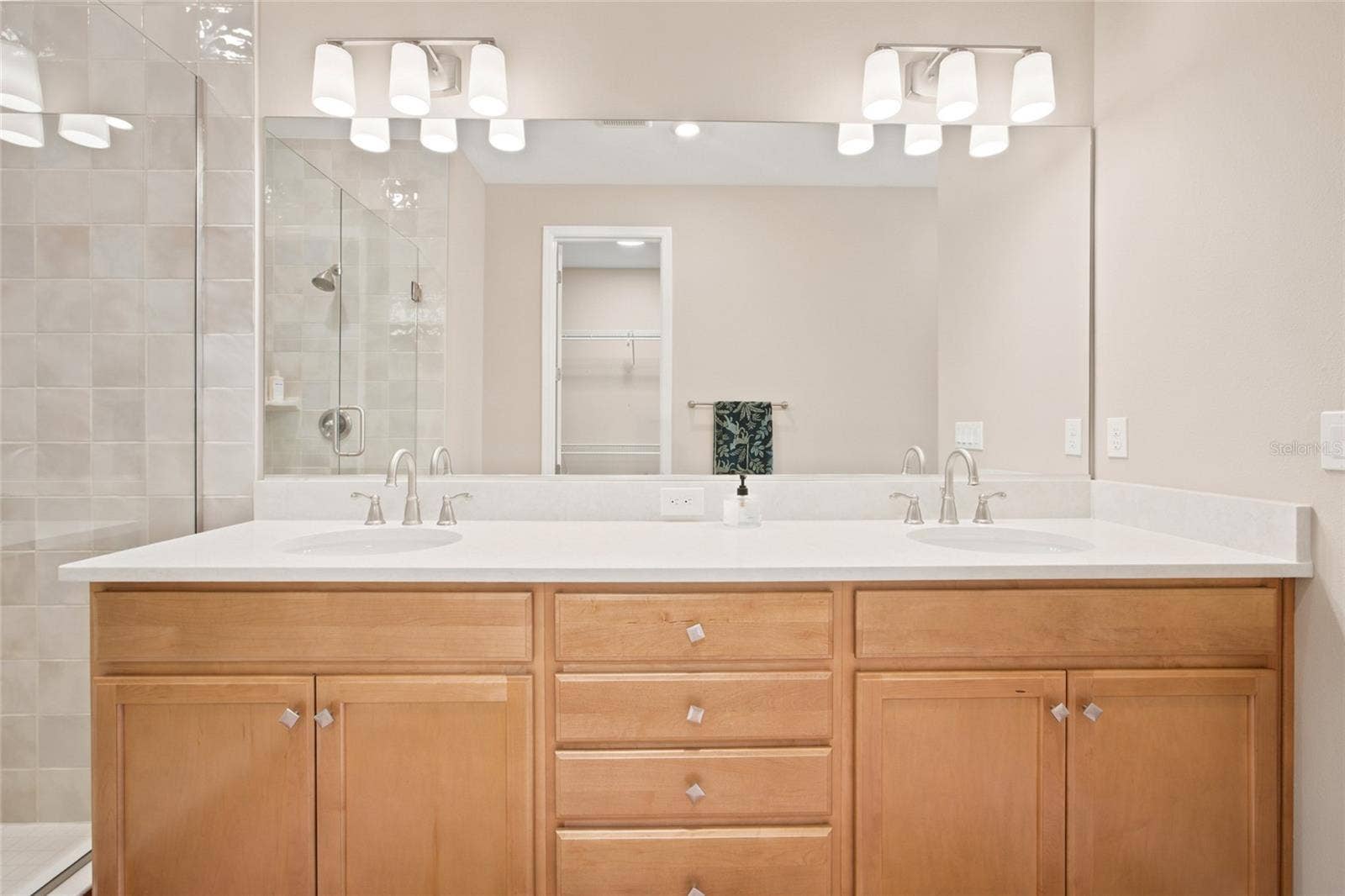 Double-sink vanity and large mirror in the primary bathroom.