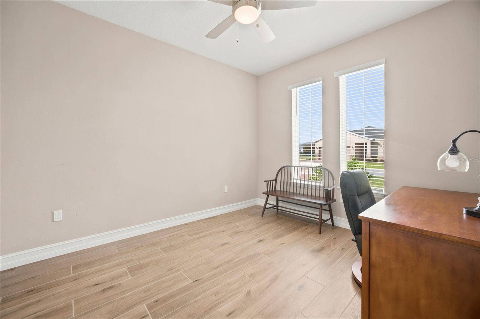 Dedicated home office with natural light and French-door entry.