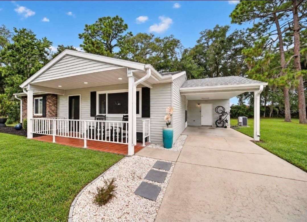 9282 SW 109TH LANE, Ocala, FL 34481 White rodk landscaping curb appeal bring charm all the way around the home.