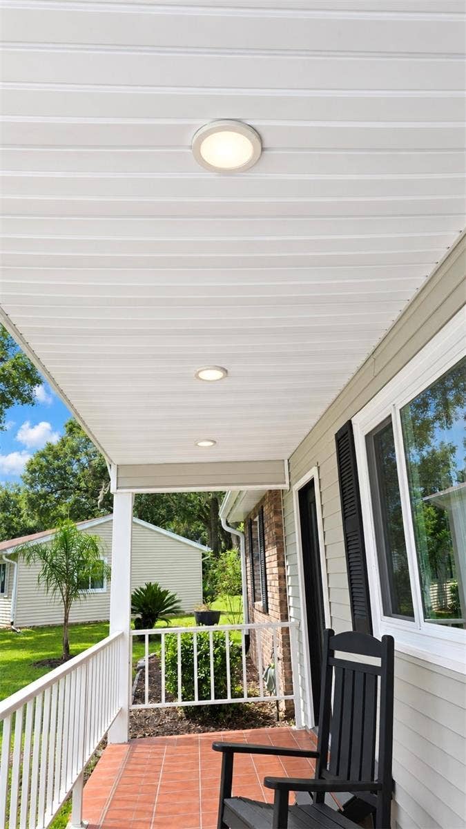 9282 SW 109TH LANE, Ocala, FL 34481 Inviting front porch for morning sunrise coffee or just rocking in your rocking chairs