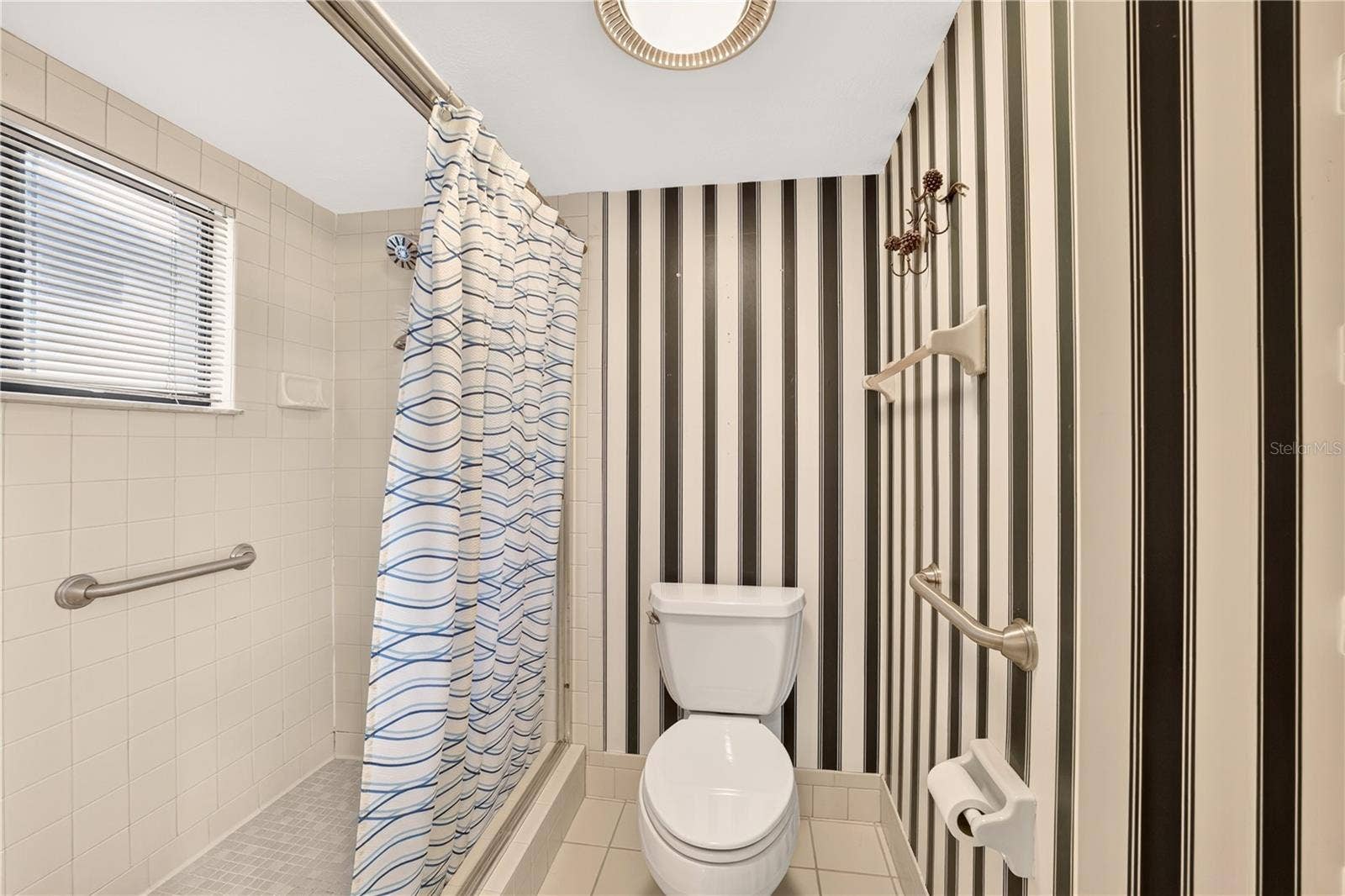 1708 NE 38TH AVENUE, Ocala, FL 34470 The shower and toilet closet have grab bars for safety